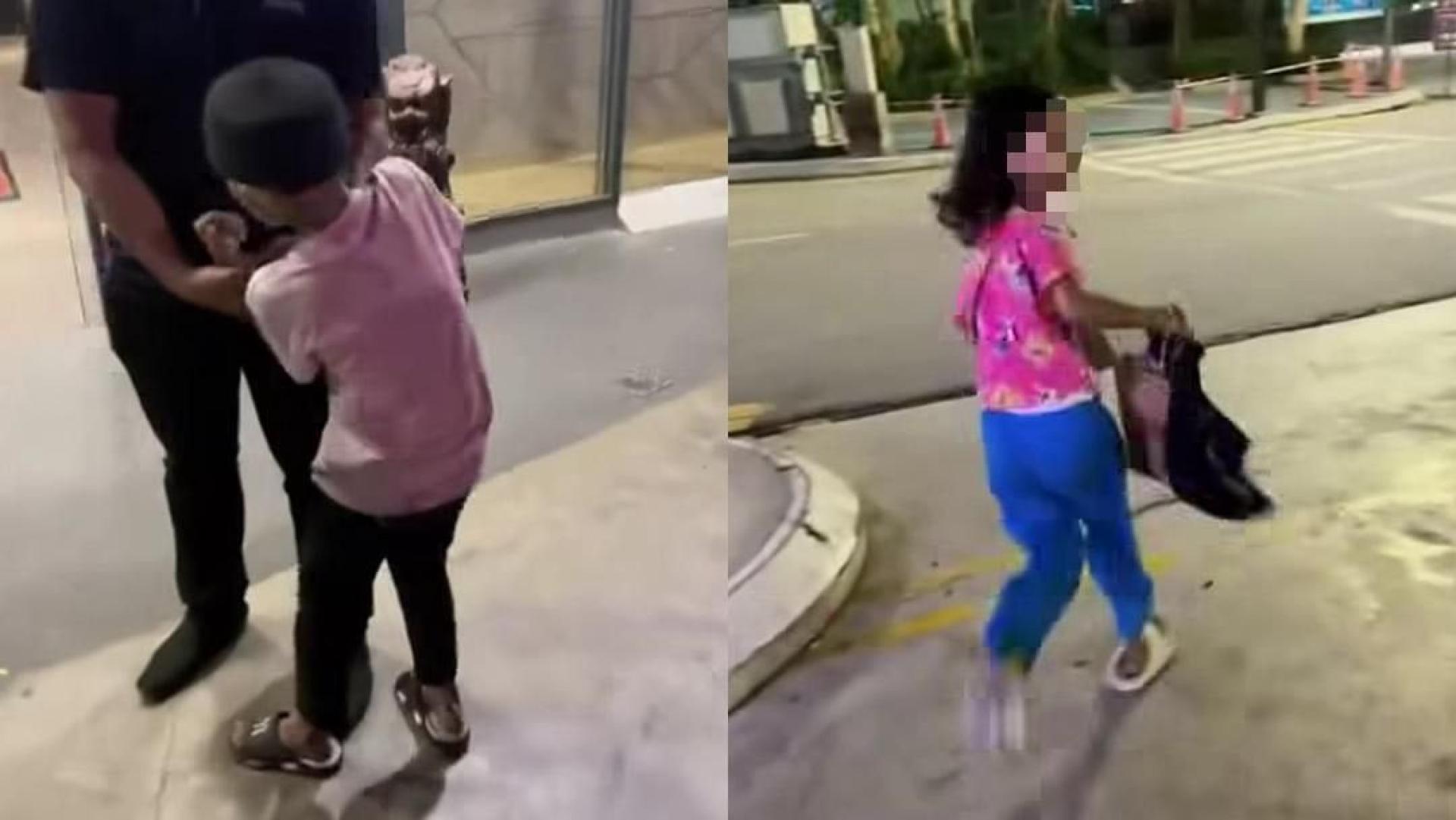男子抓住其中一名被指偷窃榴莲的男童，另一女童则逃脱。（视频截图）