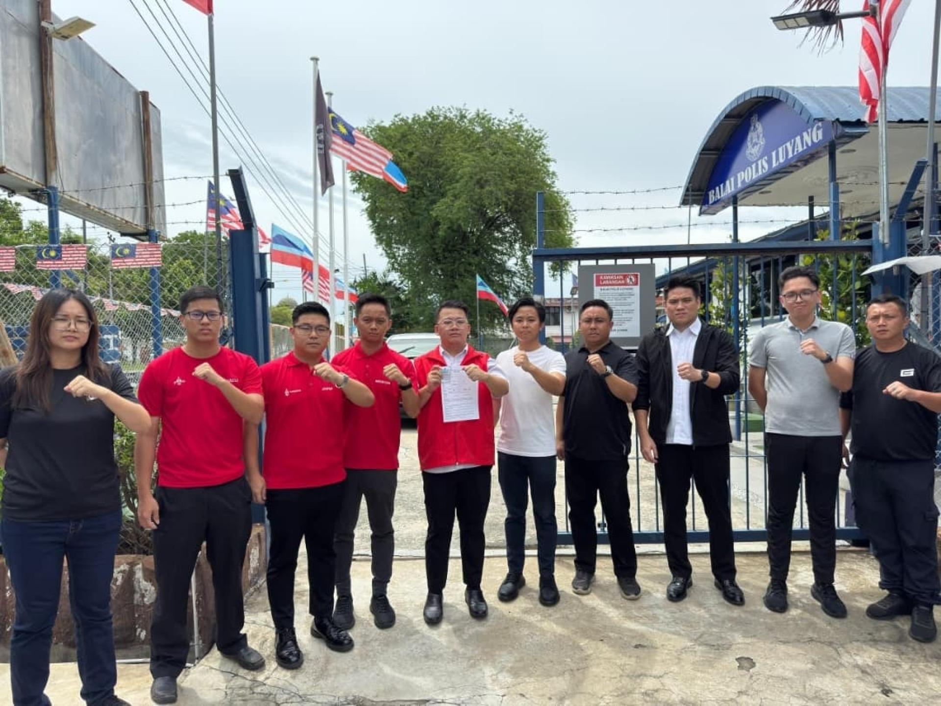 陈龙维（左5）周五率领沙巴社青团前往路阳警局报案，要求警方调查阿克马流氓行为。