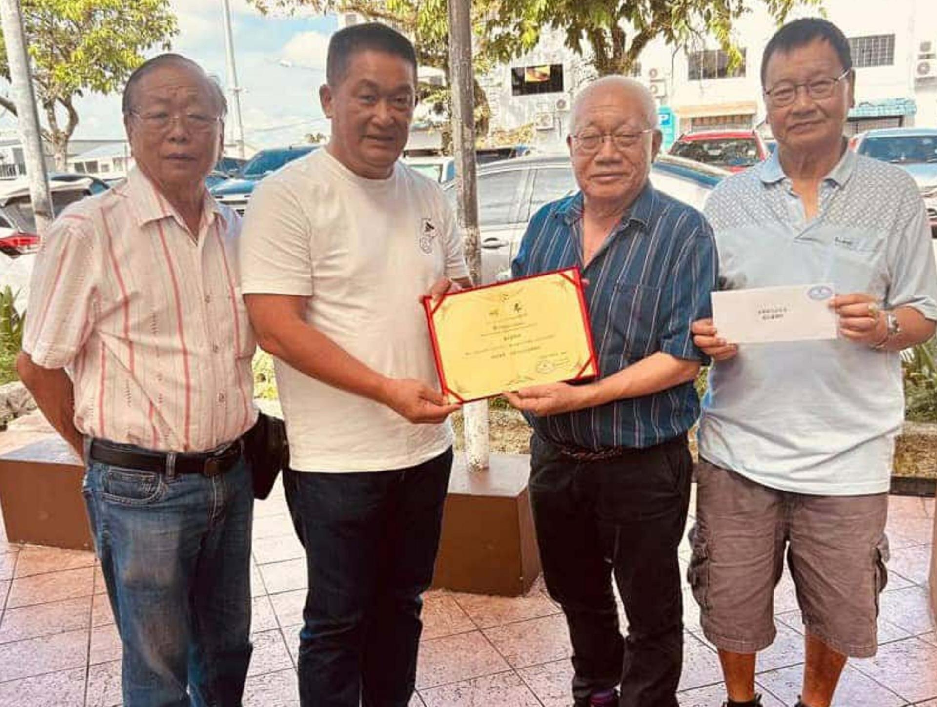 古晋河景园社区联谊会主席吴亚声（右2）递交敦聘书予巴都林当区议员施志豪律师（左2）时摄。右为第一副主席杨金生，左为第二副主席张正凤。