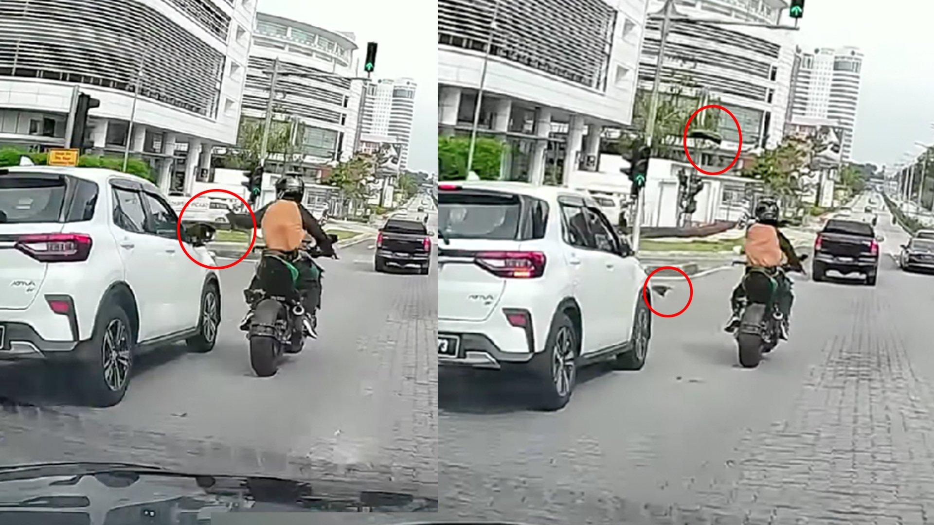 摩托车骑士大手一挥直接扫断了休旅车的后视镜。