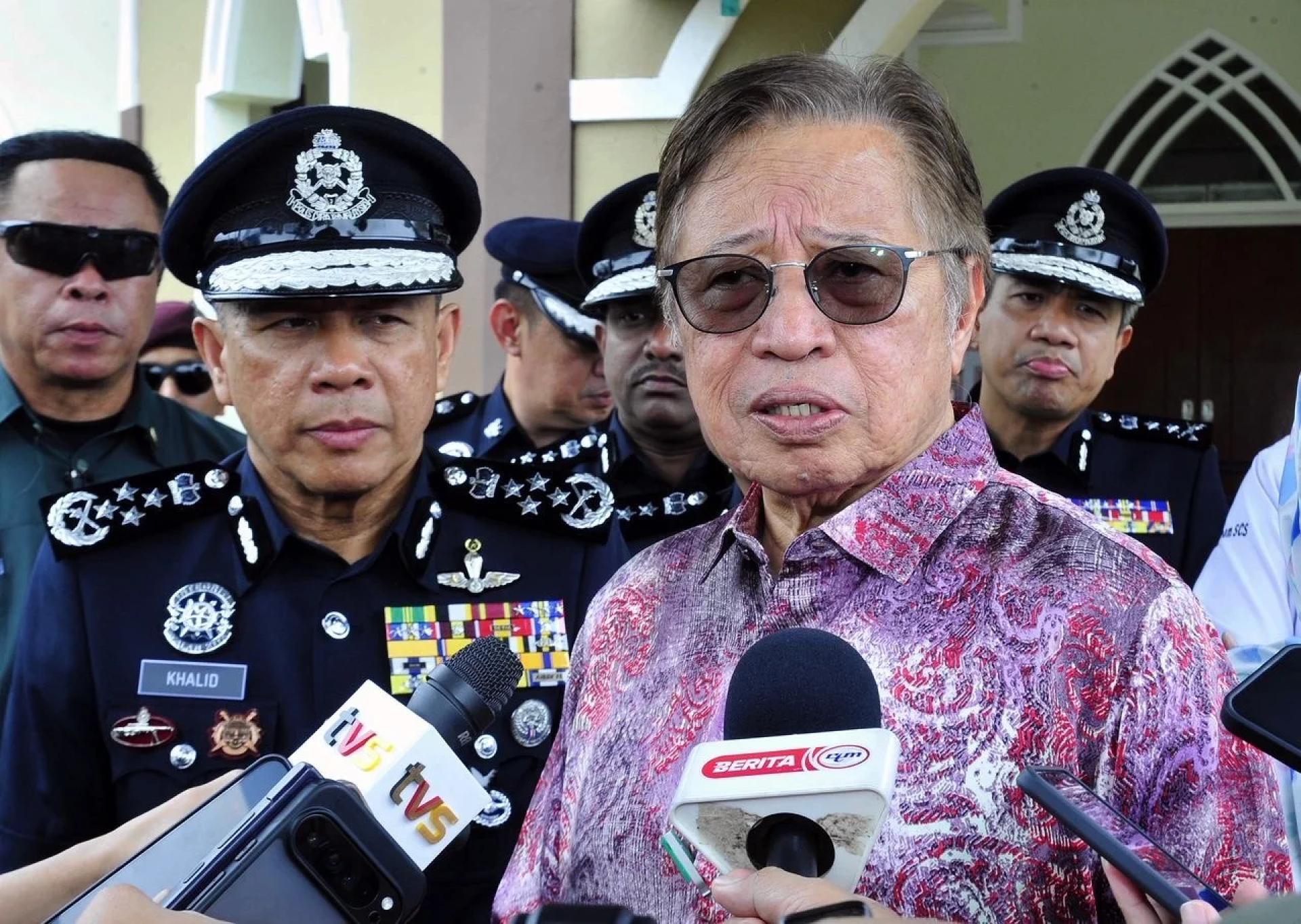 Abang Johari (right) fields questions from reporters, with Khalid on his right.