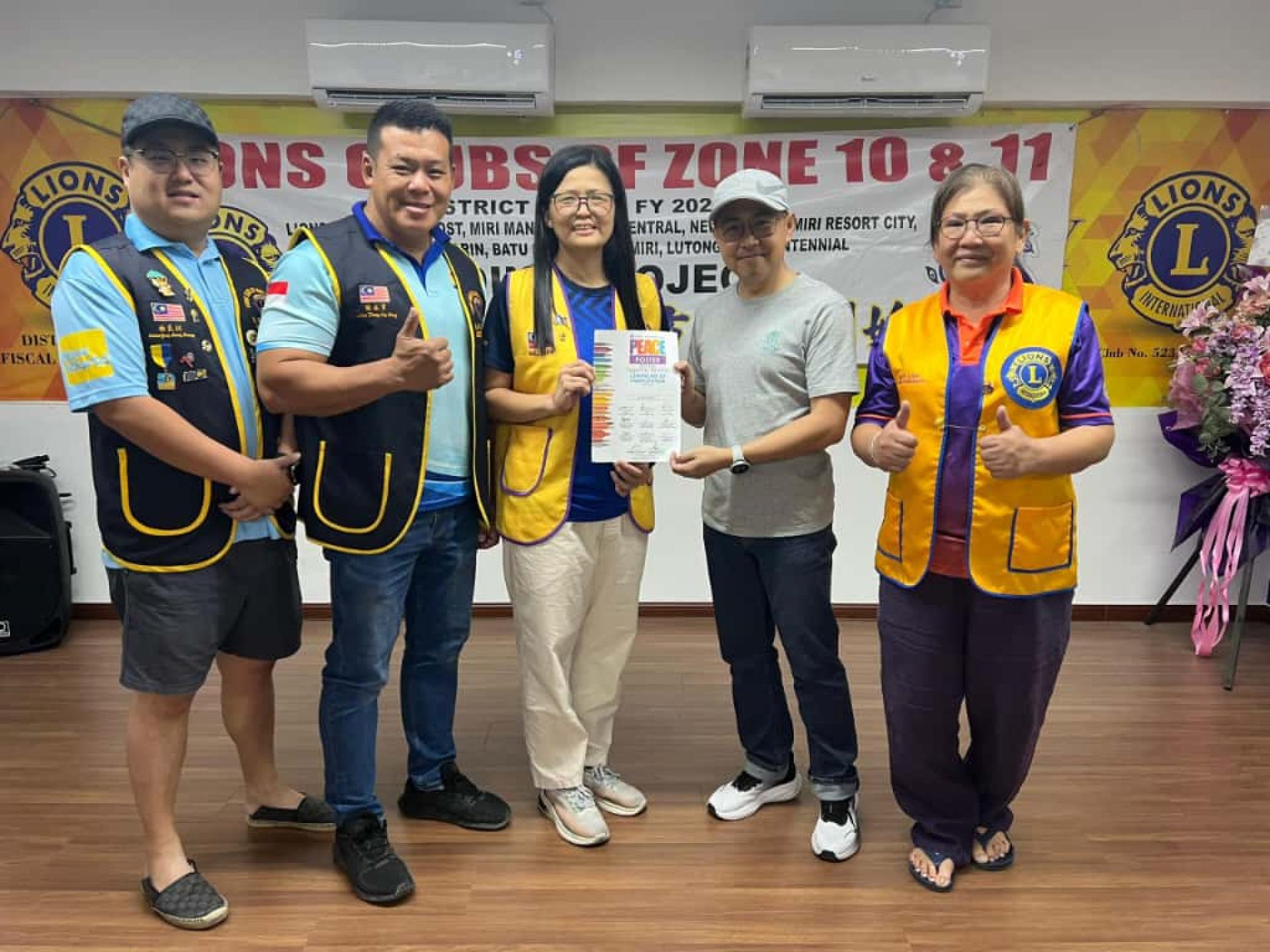 国际狮子会308A2区第四专区第11分区主席刘丽君（中）颁发感谢状予评审之一的世纪画廊执行董事李进发。左起为第10分区主席杨良权、第四专区主席张永亨；右为国际狮子会308A2区复合区前议长兼前总监刘美丽。