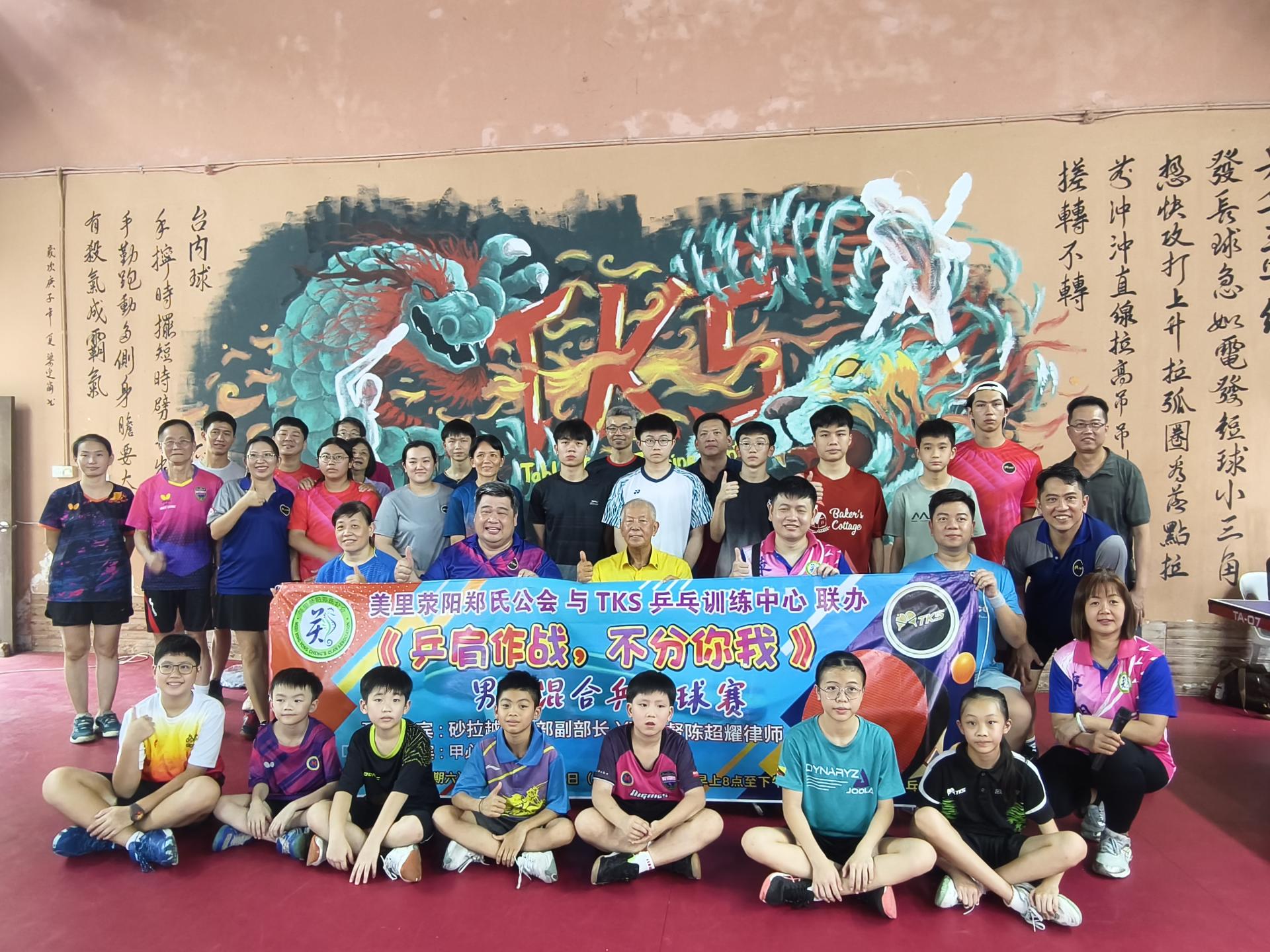 《乒肩作战，不分你我》男女混合乒乓球赛开幕仪式嘉宾与球员们合影。中排左2起为TKS乒乓训练中心馆主郑敦德、砂旅游部副部长拿督陈超耀，以及筹备会主席郑康阳。