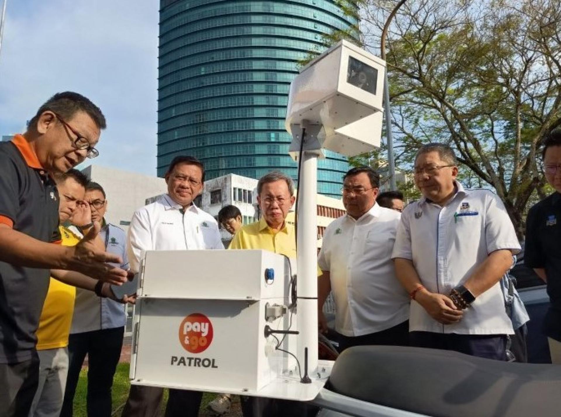 Eddie Wee Teck Tong（左）向阿都拉曼（左2）、沈桂贤、希米及黄鸿圣讲解配备车牌识别（LPR）功能的电动摩托车操作情况。