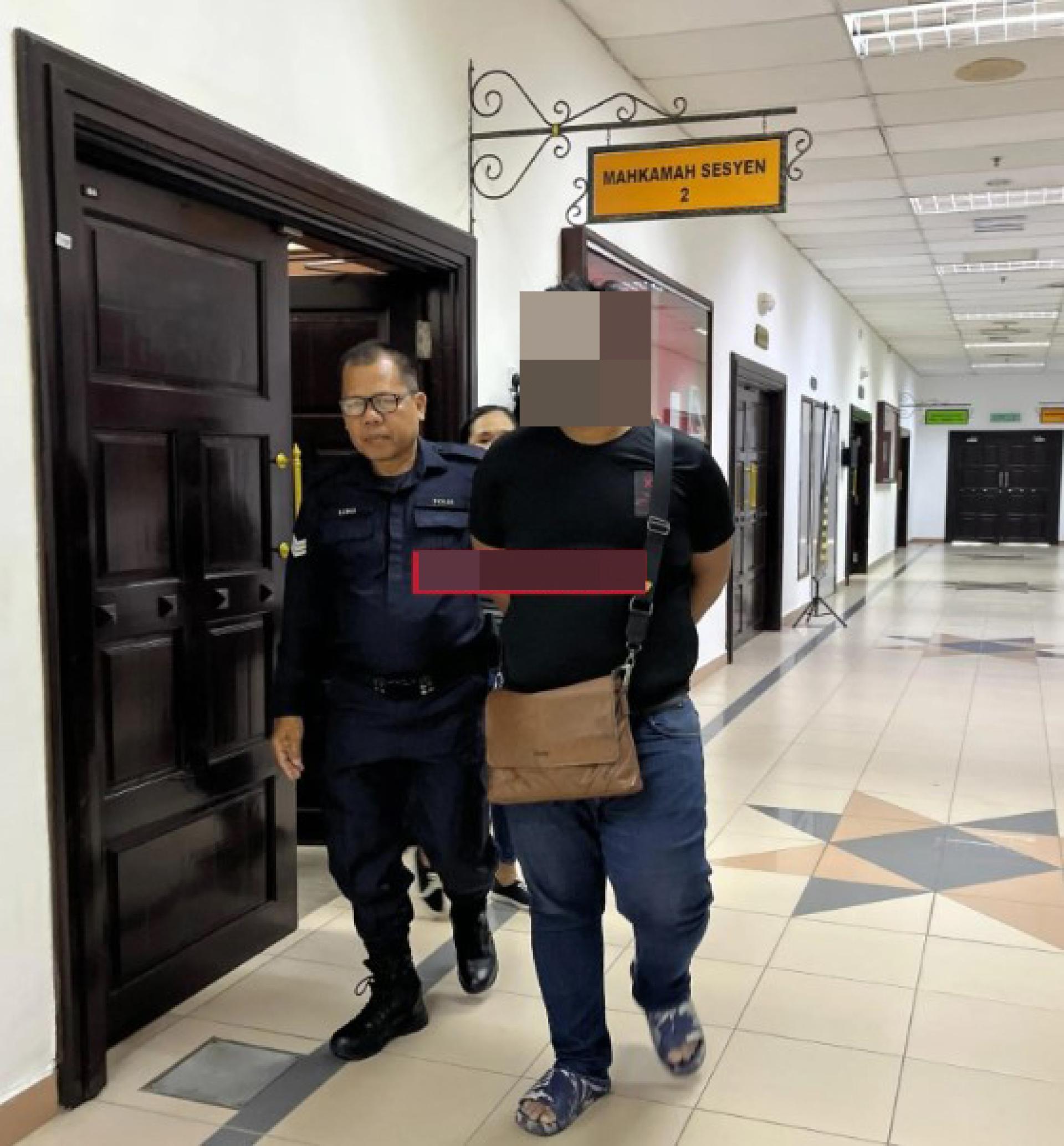 被告在警员护送下离开第二地方法院。