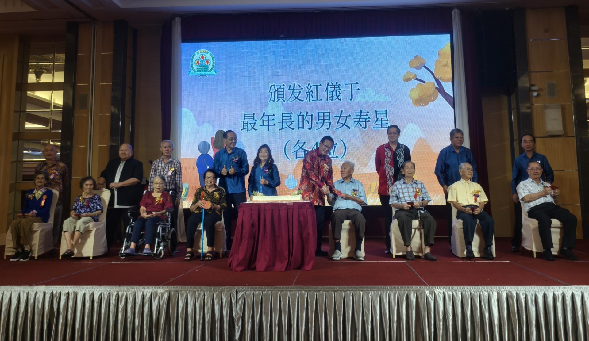 主宾砂拉越交通部长拿督斯里李景胜（站者右4）在会长黄运祥（左4）、筹备會主席梁玉珠（左）及嘉宾们陪同，一同颁发红仪于最年长的 8 位男女寿星。