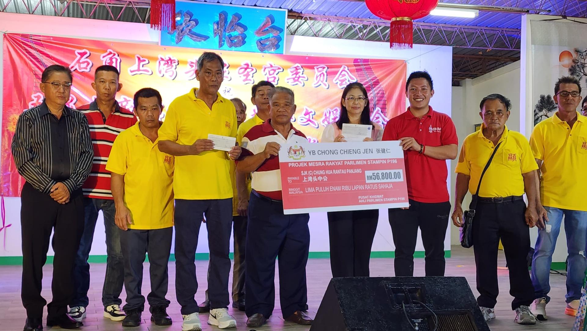 沈杰龙（右3）在众人的陪同下，移交拨款支票予石角上湾头中公校董会主席温庆利（右5）。左4为上湾头显圣宫主席黄志兴。