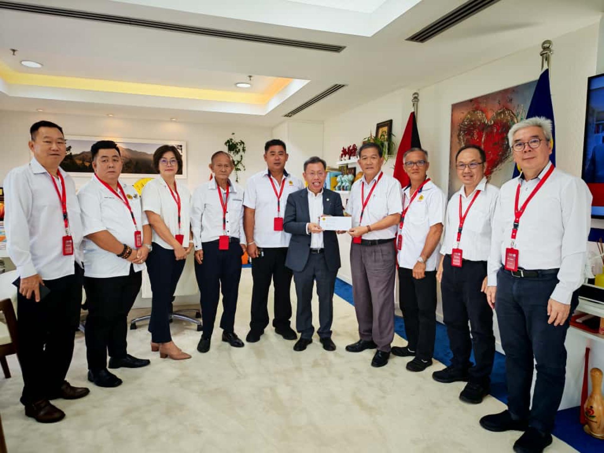 石角支部主席兼晚宴筹备会主席林亚德（右4）移交邀请函给党中央主席拿督阿玛沈桂贤。在场右起为筹备会宣传陈石平、秘书蔡汉菁、副主席沈燕财、主席林亚德、党中央主席沈桂贤、副主席甲必丹刘源熙、票务蔡高仁、接待甲必丹温淑萍、纪念品曾俊凌及财政黄永东。