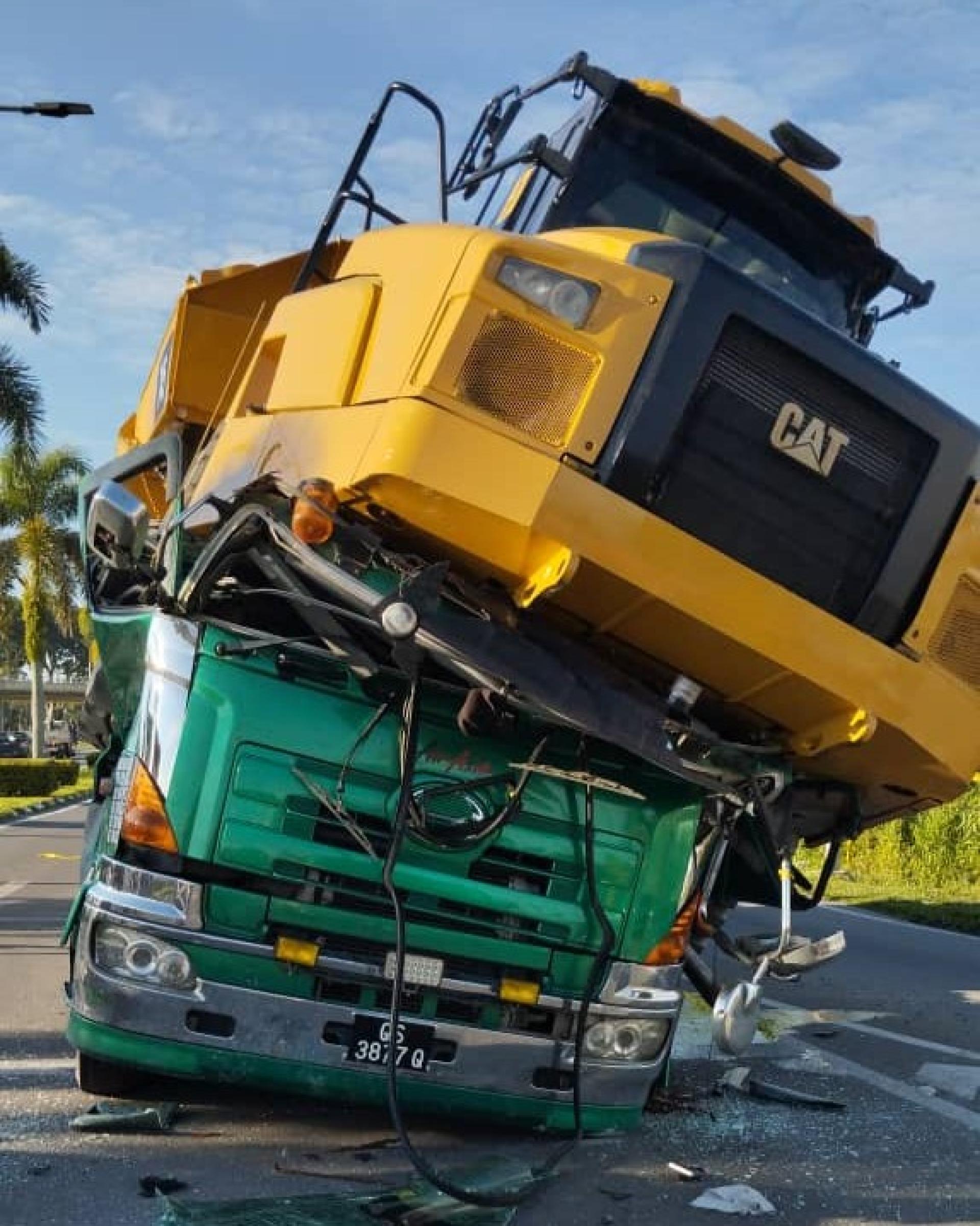 一辆载有重型机械的拖格罗里司机与随车助手双双夹毙驾驶舱内，当场被证实身亡。