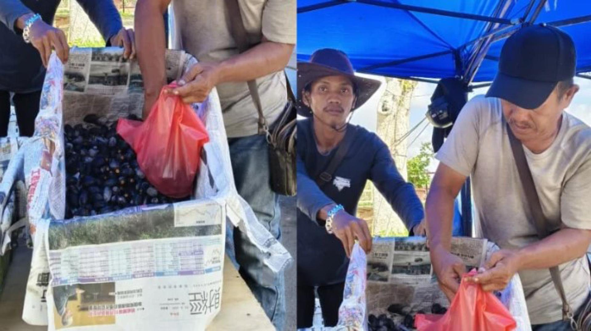 朱奈迪在朋友的帮助下展示在泗里街出售的达拜果。