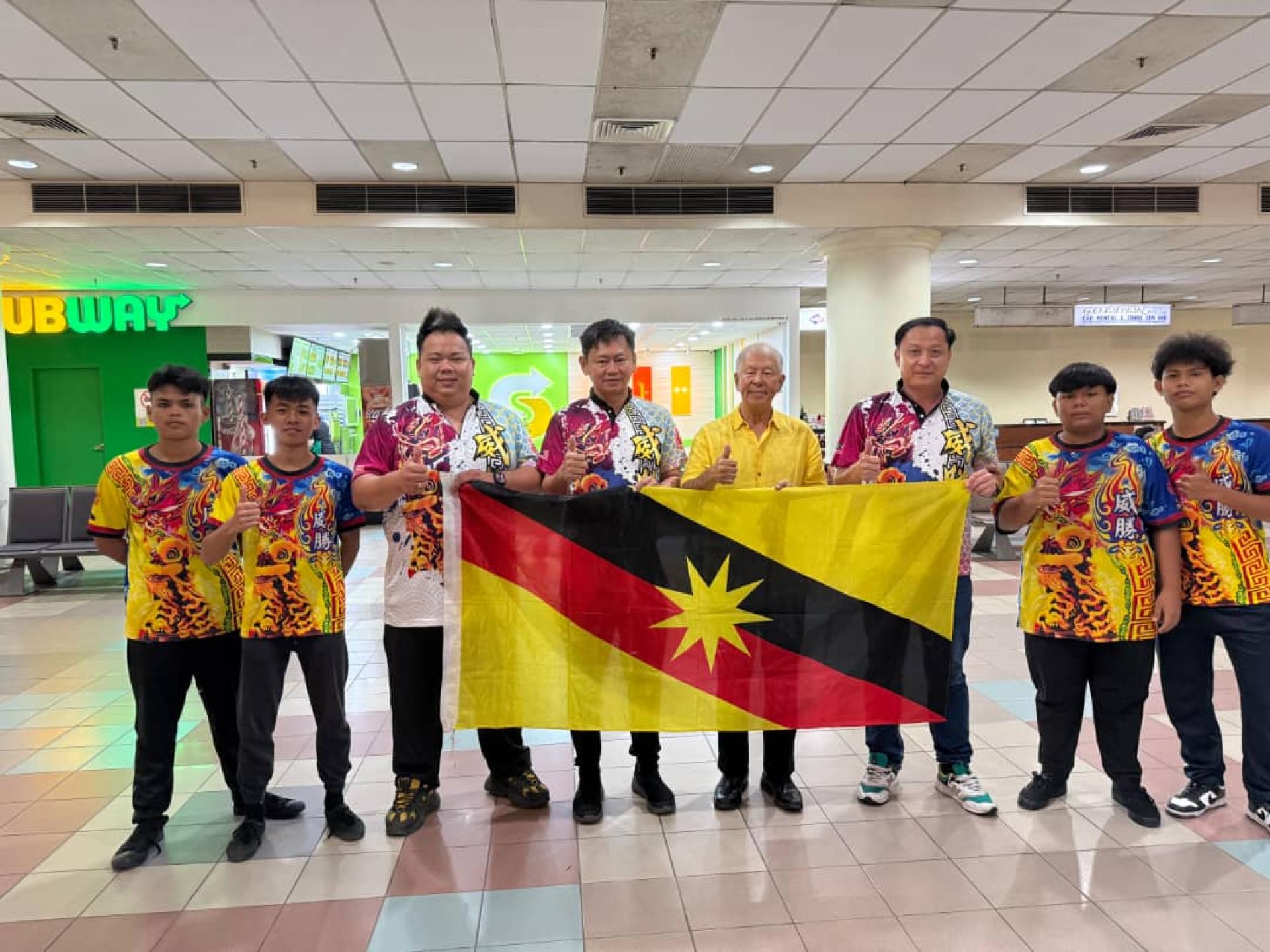 砂拉越旅游副部长拿督陈超耀（左5）授旗予该团主席池志达（右3）。