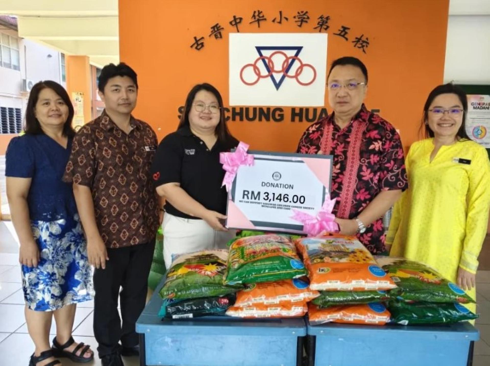 古晋、三马拉汉及西连中华小学校董管理协会主席拿督Jonathan Chai Voon To（右2）将捐款移交给SCCS代表Boon Siaw Ying（中），Tay Kok Ing（右）见证。