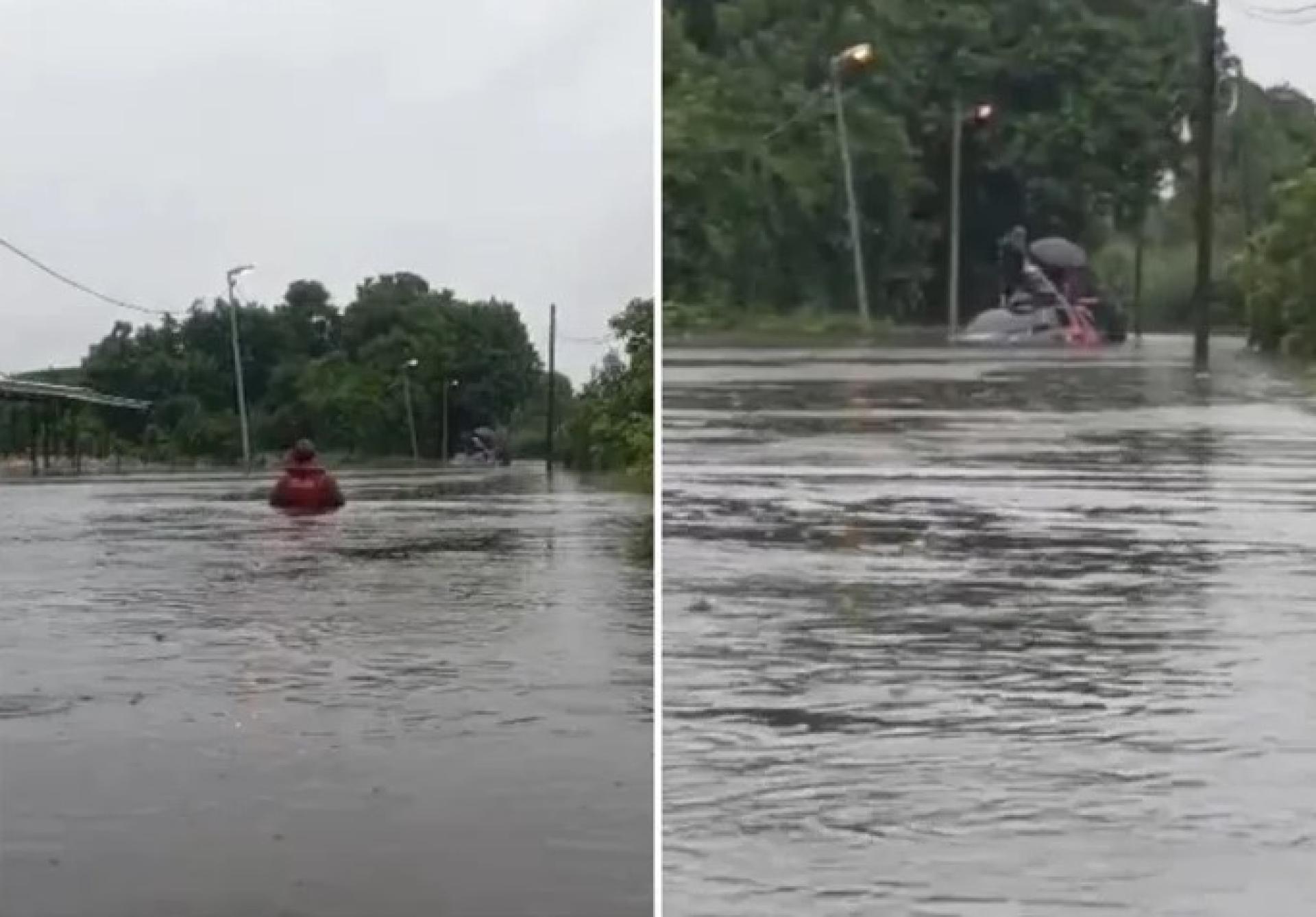 尼亚石山消防队员涉水至胸高的洪水中，救援2025年12月9日在Sepupok Niah Jalan Penerangan被困四驱车上的受困者。