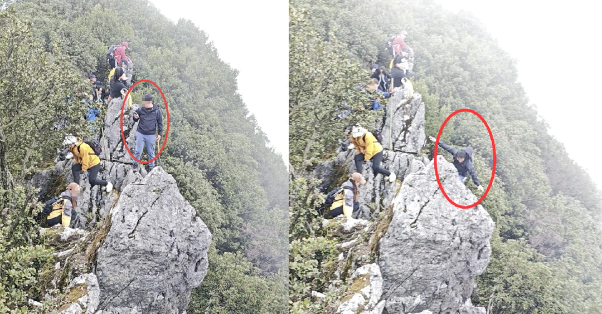 身穿黑衣的男子右手持手机，双脚分别踩在山体与突出的石块上。突然，他左脚踩着的石块松脱，男子随即跌落悬崖。