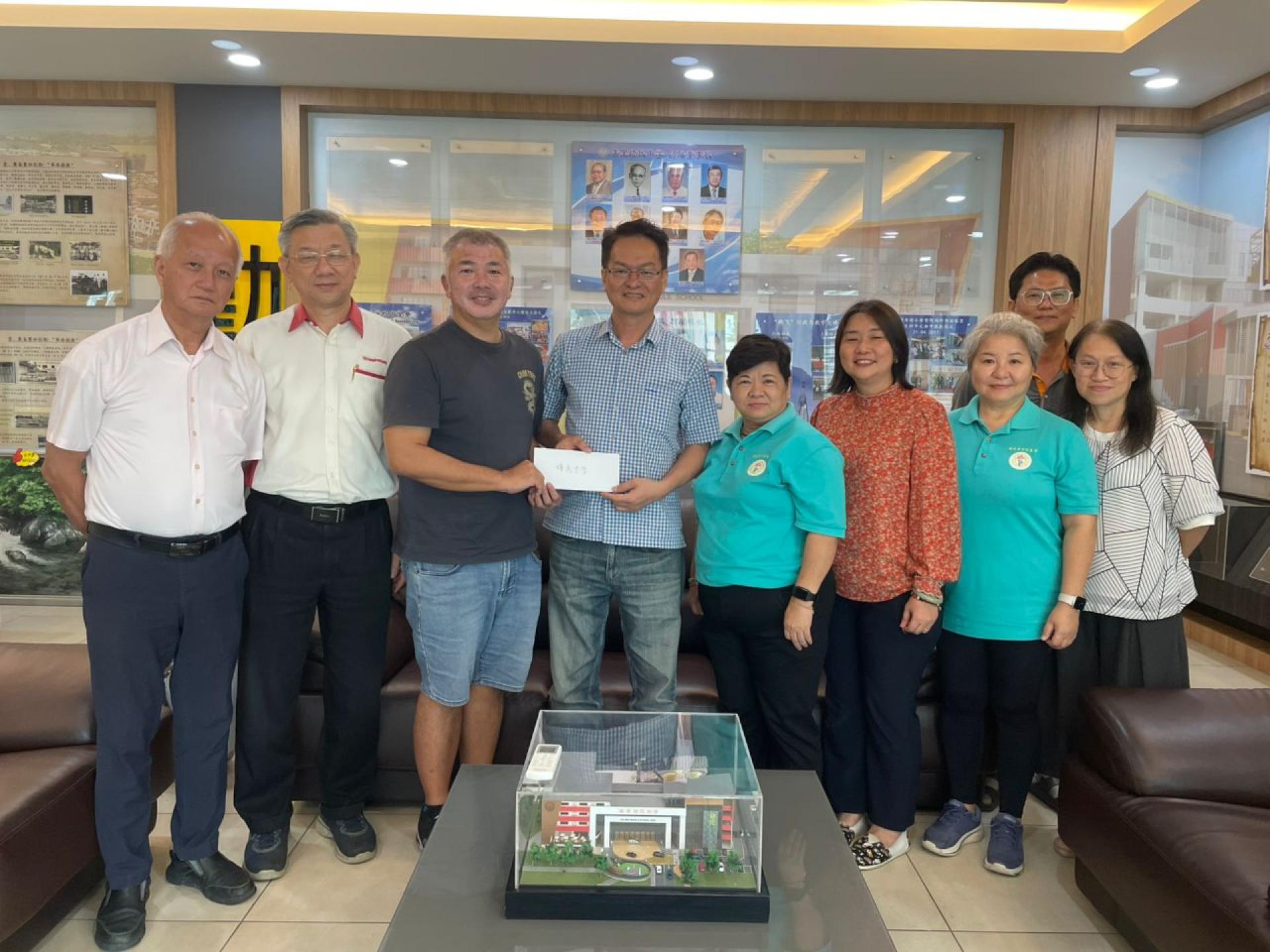 培民中学1994年高三甲班校友钱有泉（左三）将该班校友所筹到的教育金移交予培中董事财政沈木桂（左四）时摄。左起为董事傅楚旺，董事秘书林启瑞，右起校友谢静娴，校友张颖杰，培中校友会林欣蕾，校长贝美娇，校友会主席黄金凤。