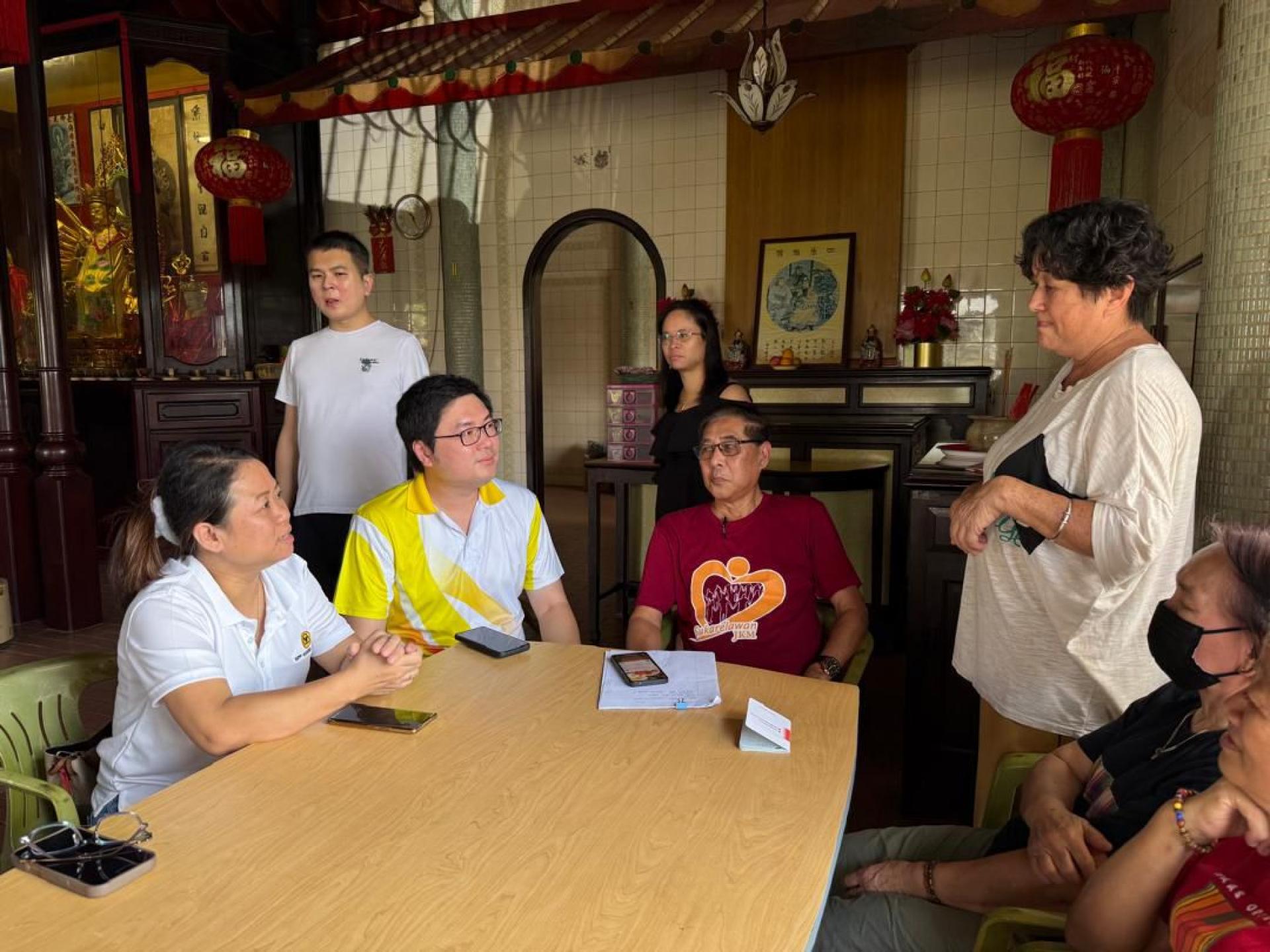 黄笃荣与福利义工工作者庄诚德和古晋观音白衣会探讨帮助长者申请福利事宜。