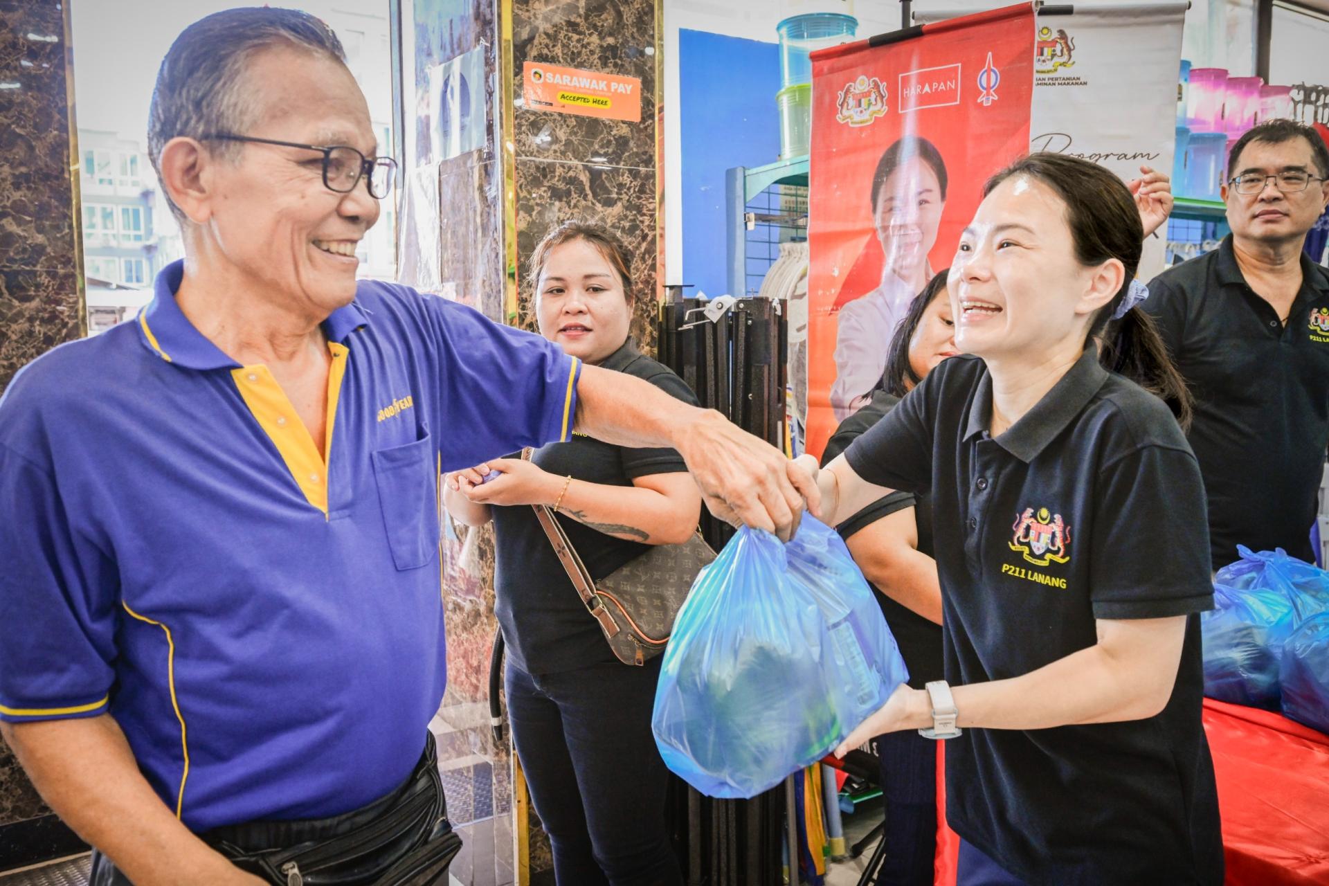 南兰区国会议员刘强燕（右）移交食品配套予民众。（档案照片）