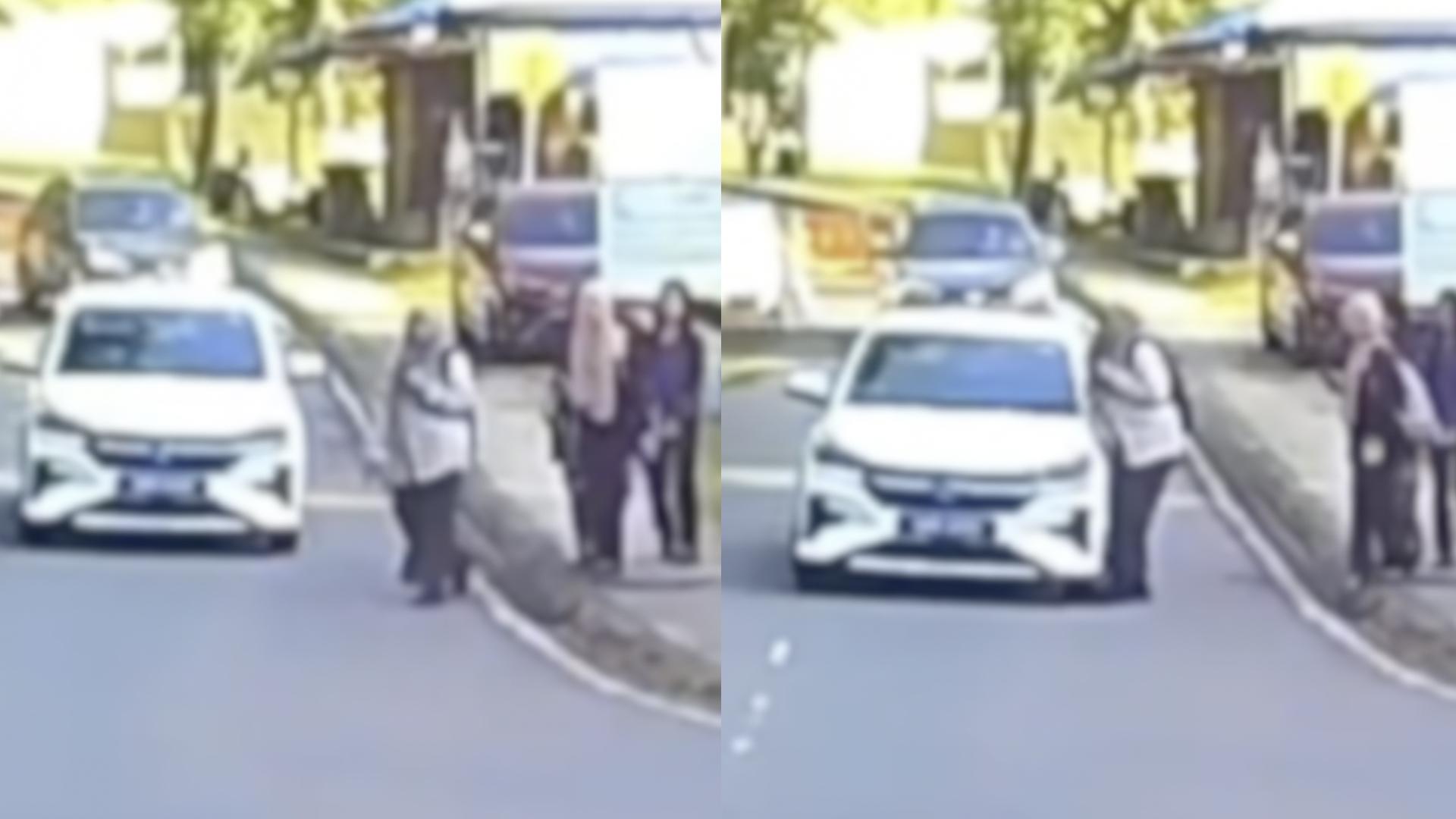 一名女子在过马路时完全没有注意车辆，直接“撞”了车的侧面。