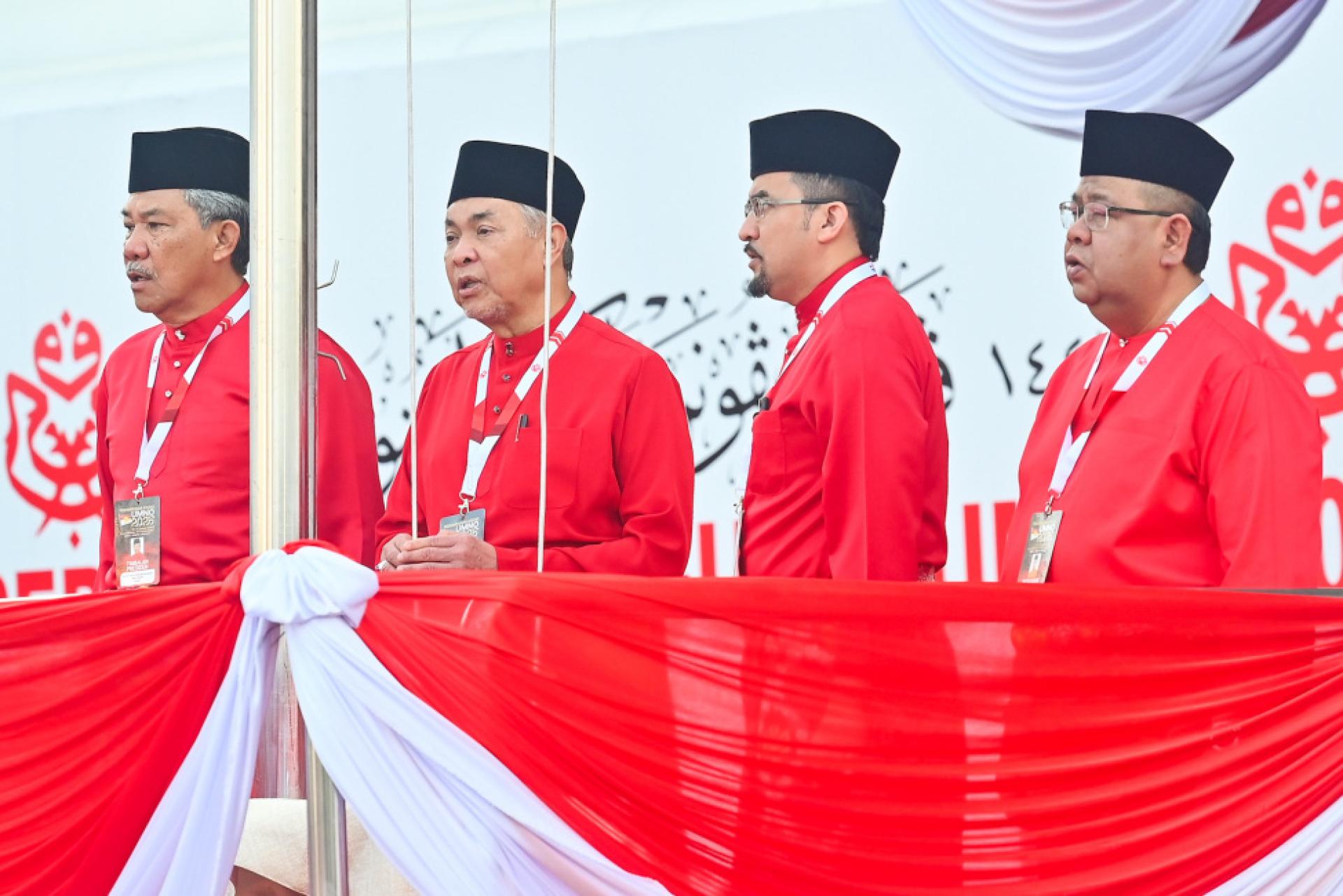 阿末扎希（左2）主持巫统大会开幕前的升旗仪式，在场的有莫哈末哈山（左1）及阿斯拉夫（右2）。