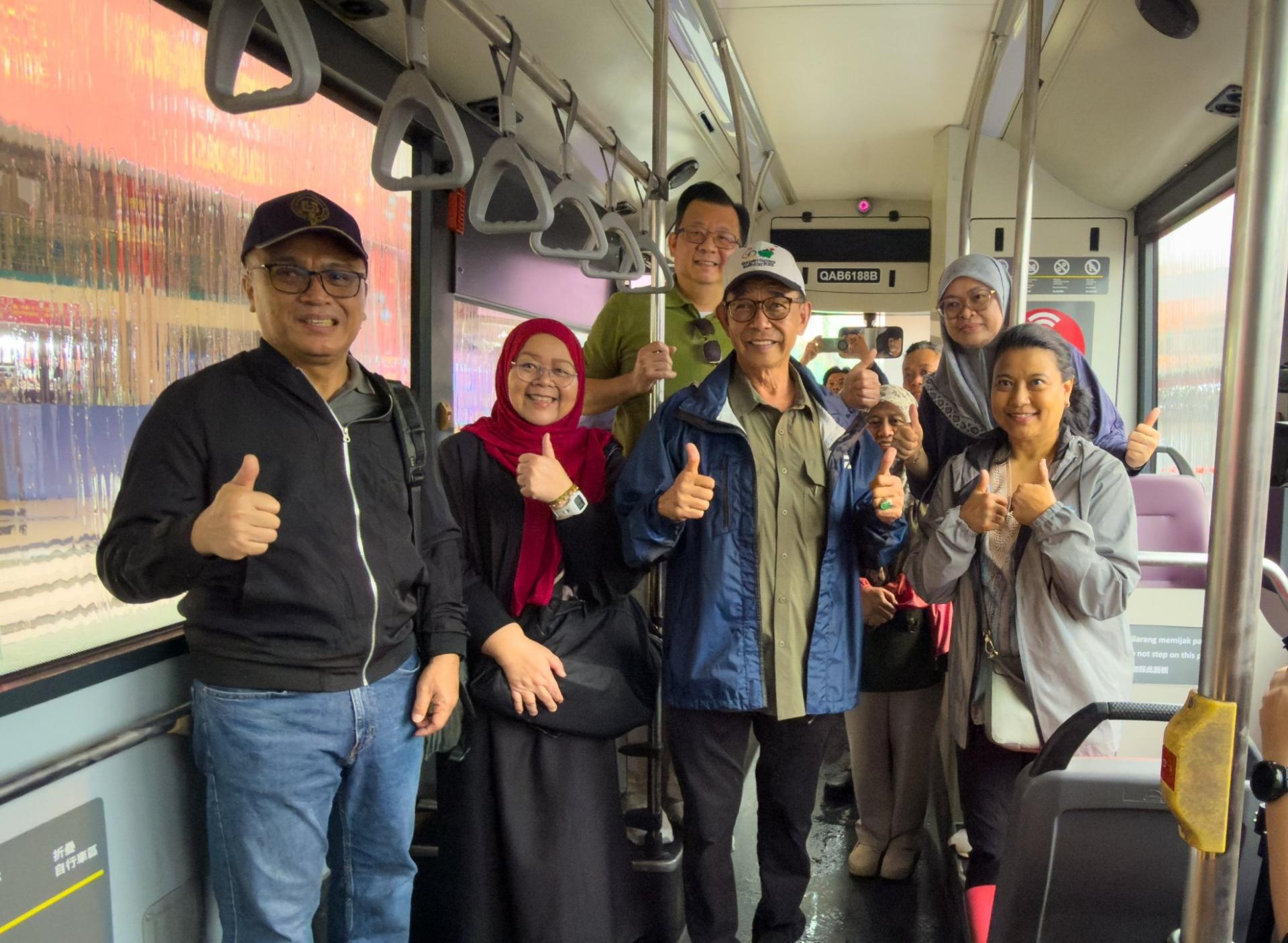 拿督斯里阿都卡林（左3）搭乘103号公交车并竖起拇指赞好。