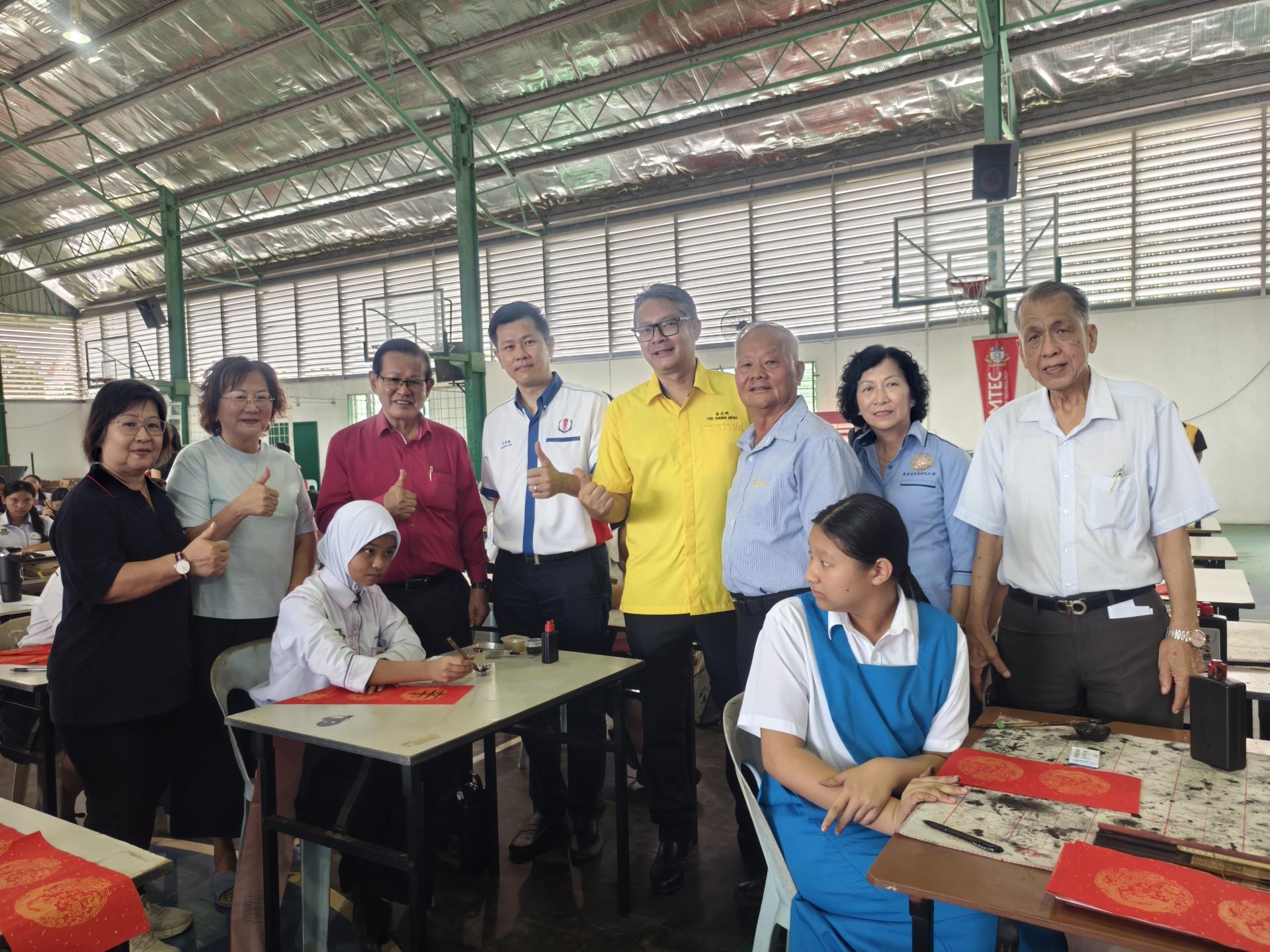 来自不同族群的学生踊跃参与挥春比赛，展现砂拉越多元文化共融特色。 图左起为黄优芳、本固鲁方凤金、拿督斯里李景胜、美里省华总会长许信隆、美里市议员余忠明、拿督斯里刘久健、筹备会主席 许美链及拿督斯里刘贤仕现场巡视。