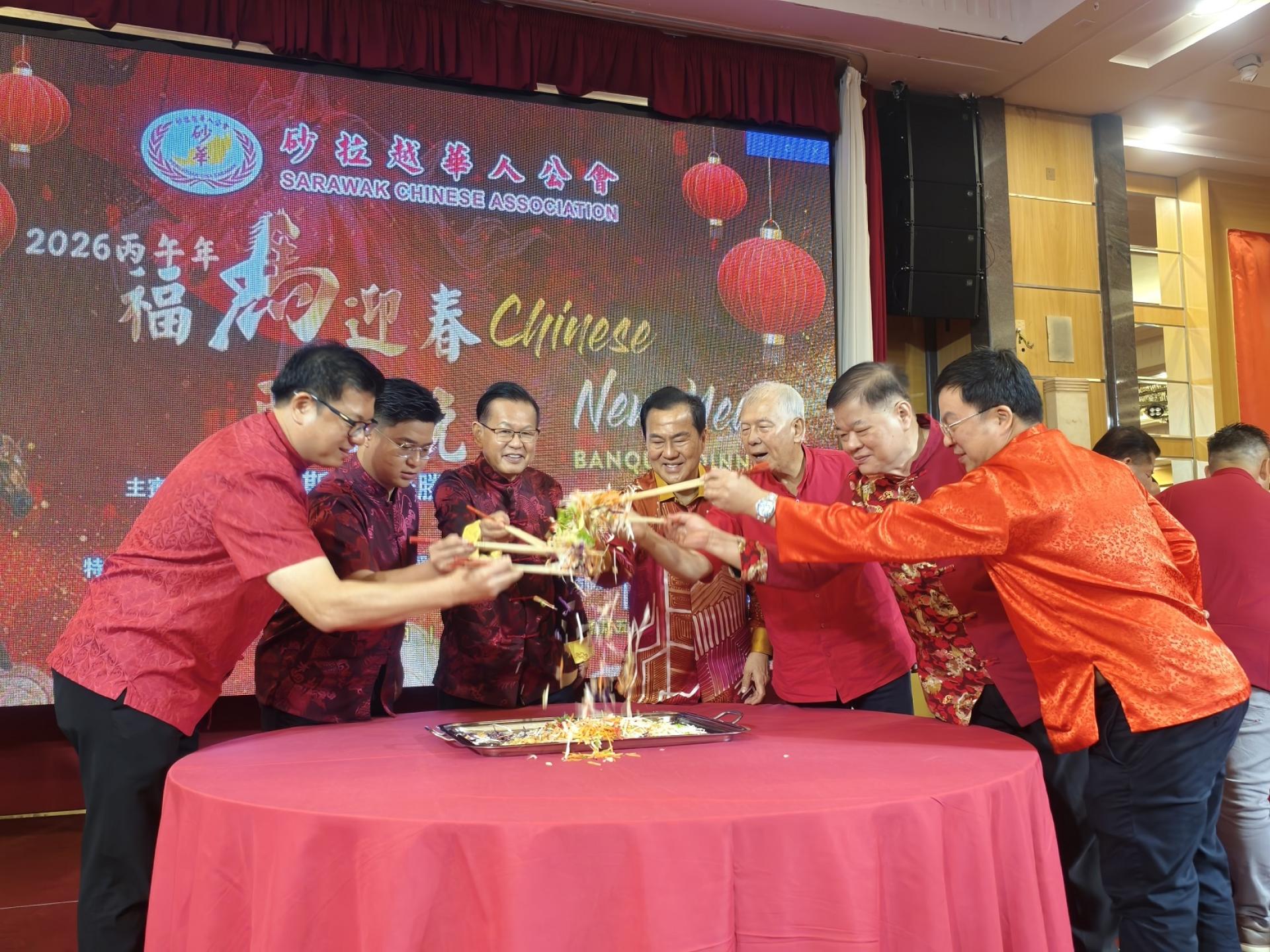 主宾席要员带领全场齐捞生。左起为美里市长兼埔奕区州议员俞小珊的代表范宏祥市议员、马来西亚旅游、艺术及文化部副部长兼美里国会议员赵俊文律师的代表邹梓建、主宾砂拉越交通部长拿督斯里李景胜、砂拉越华人公会永久名誉顾问拿督许庆璋、砂拉越旅游副部长兼卑尔骚区州议员拿督陈超耀、美里中华总商会理事长林昌陞，以及砂华会长李天送。