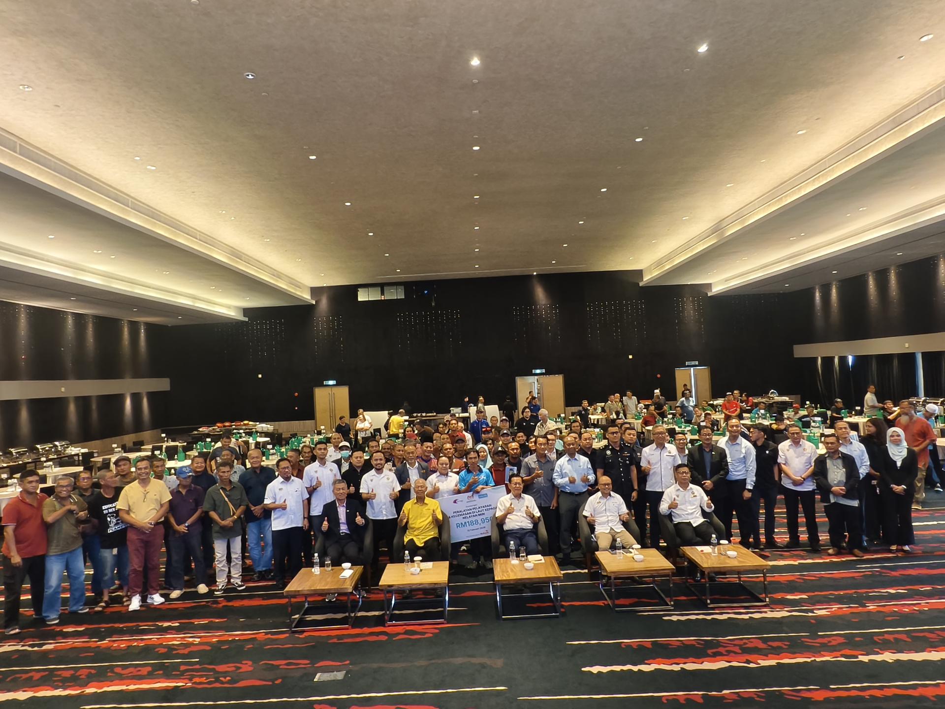 移交海上航行及紧急设备予美里渔民仪式后，众嘉宾和与会者合影。坐者左起为DIALOG集团健康、安全与环境（HSE）执行董事兼DIALOG Services（Sarawak）私人有限公司董事包久怀，砂拉越旅游副部长兼卑尔骚区州议员拿督陈超耀，砂拉越交通部长兼史纳汀区州议员拿督斯里李景胜，砂拉越海洋渔业局高级主管拉赫曼瓦哈。