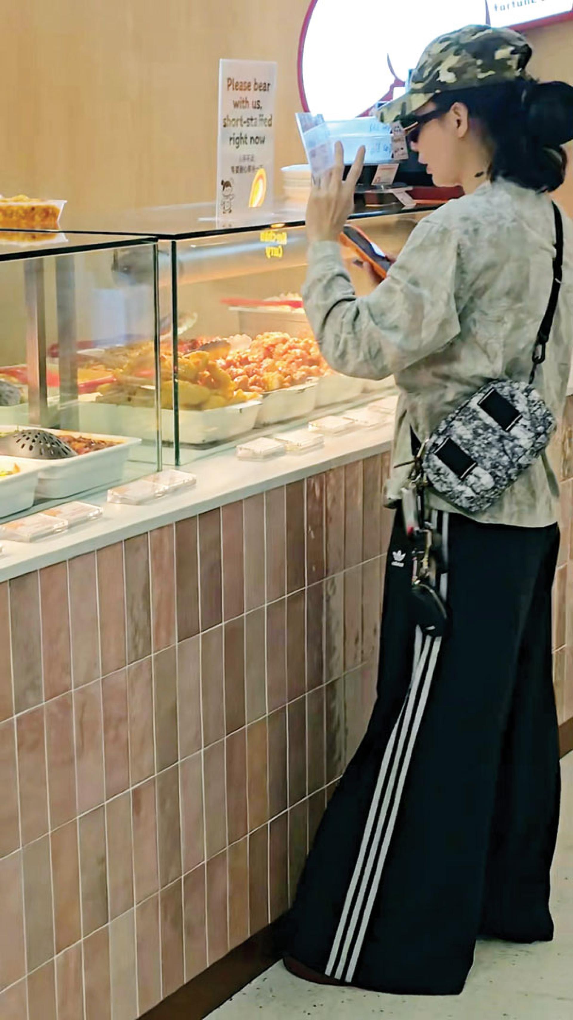 张柏芝在澳洲悉尼的美食街点餐，装扮低调却不失时尚感。