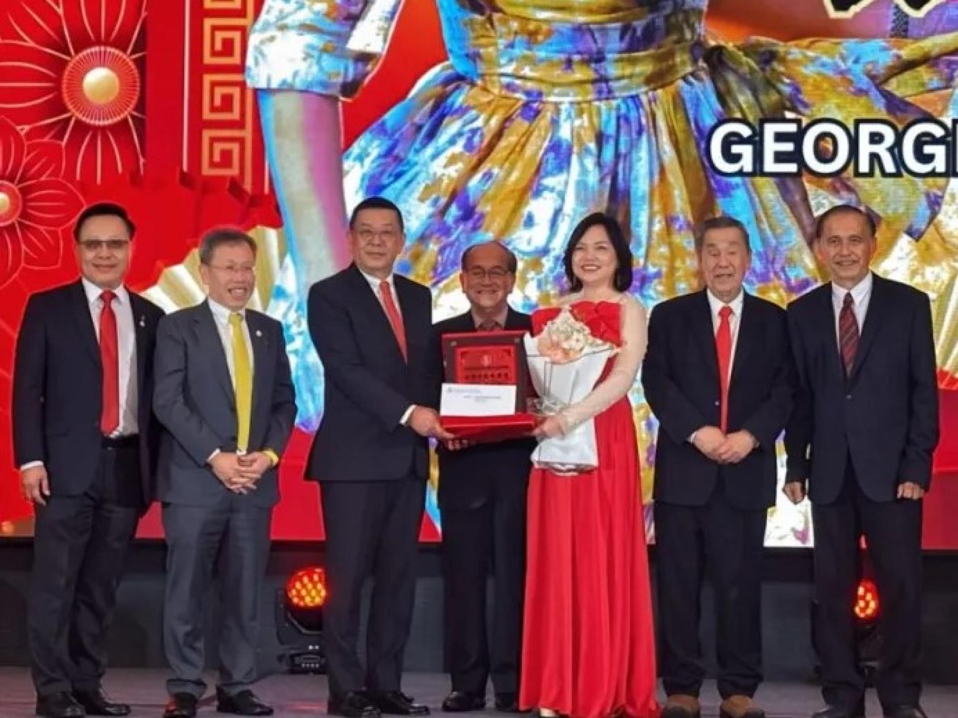 黄良杰（左3）在3月1日活动中，将奖牌颁发给张维乔（右3），道格拉斯（中）见证。