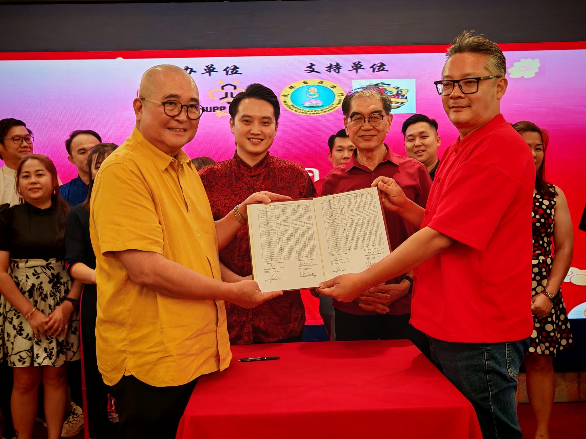 就职典礼上，俞小珊（左1）移交宣誓书予珠巴分部团长余忠明（右1），标志新一届团委正式就职。