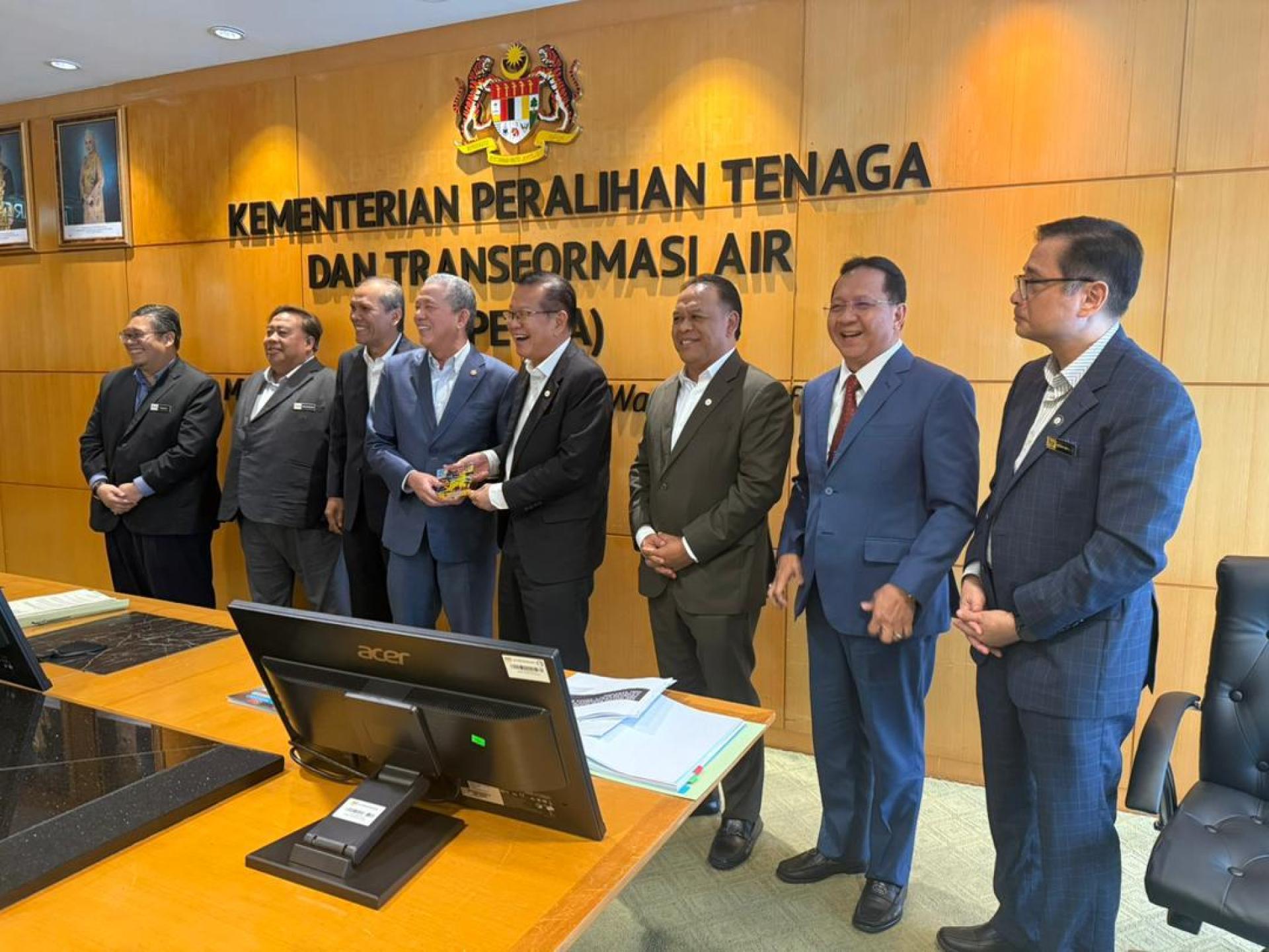 拿督斯里李景胜（右4）赠送纪念品给副首相拿督阿玛法迪拉尤索（左4）。