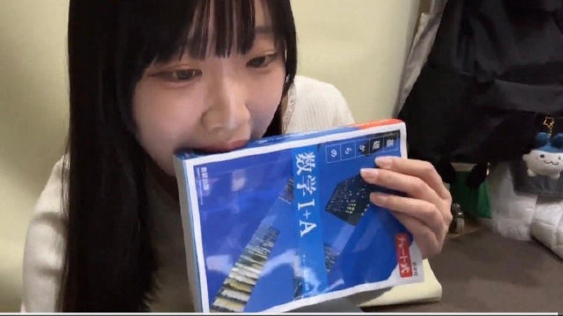 日本少女在拍卖前特地将书本“含了一口”，以口水为书本加持。