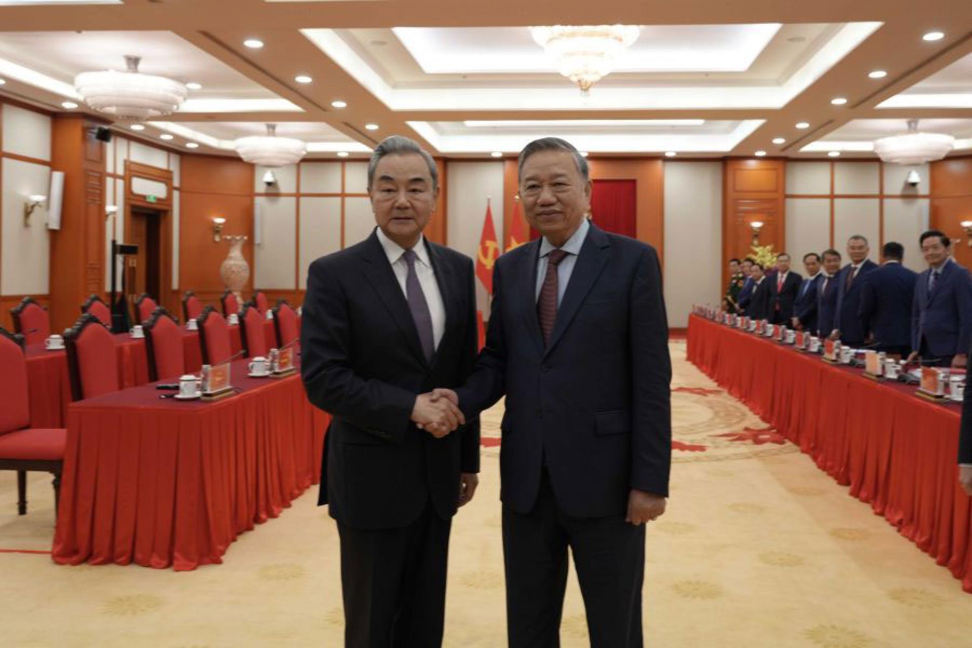 越共中央总书记苏林（右）与中国外交部长王毅（左）握手。