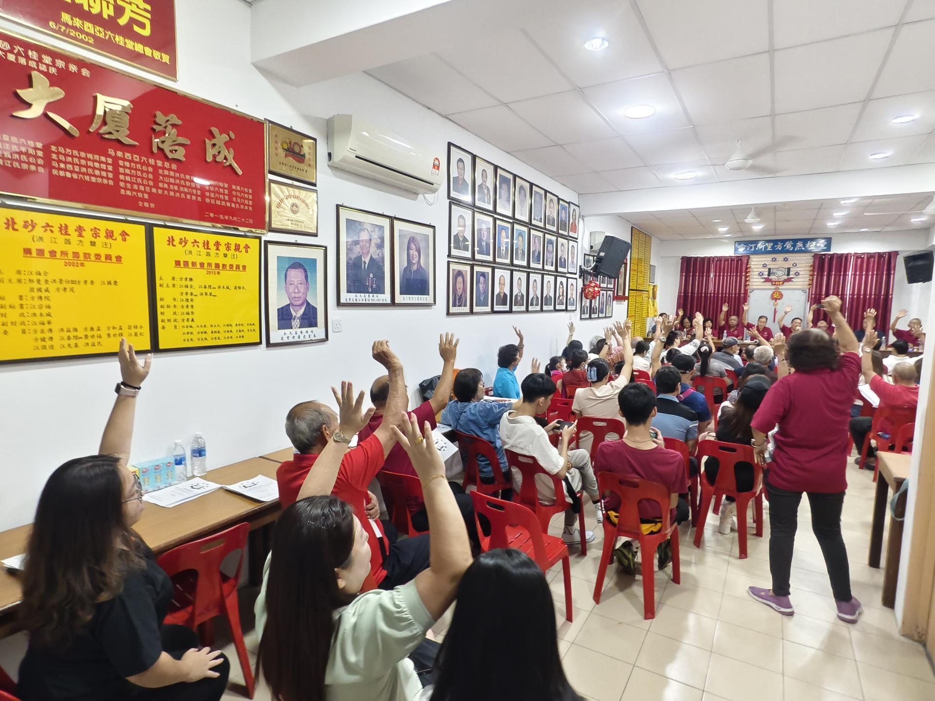 出席会员举手表决同意继续进行召开会员大会。