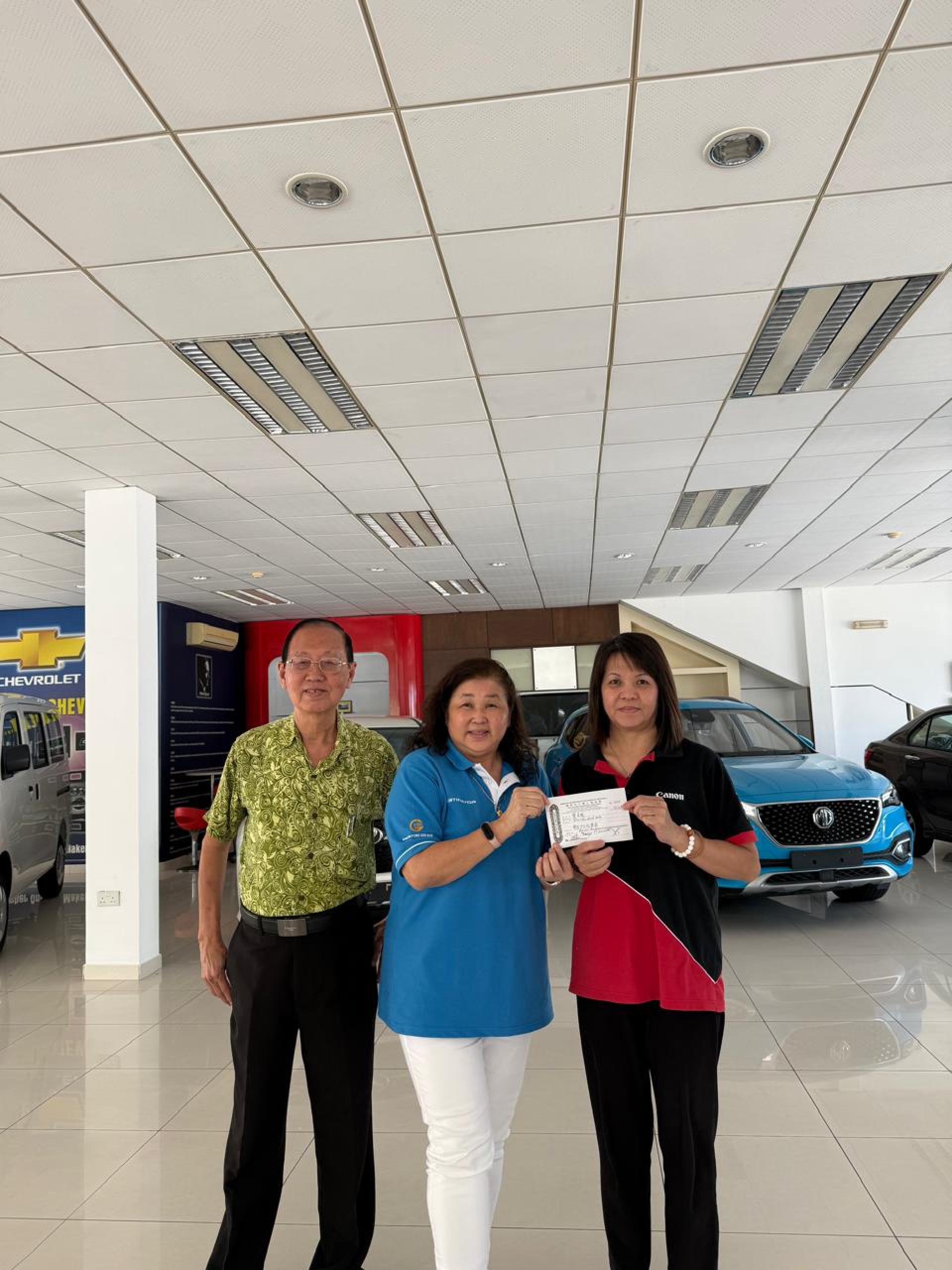 黄美凤移交善款，左为郑炳光见证