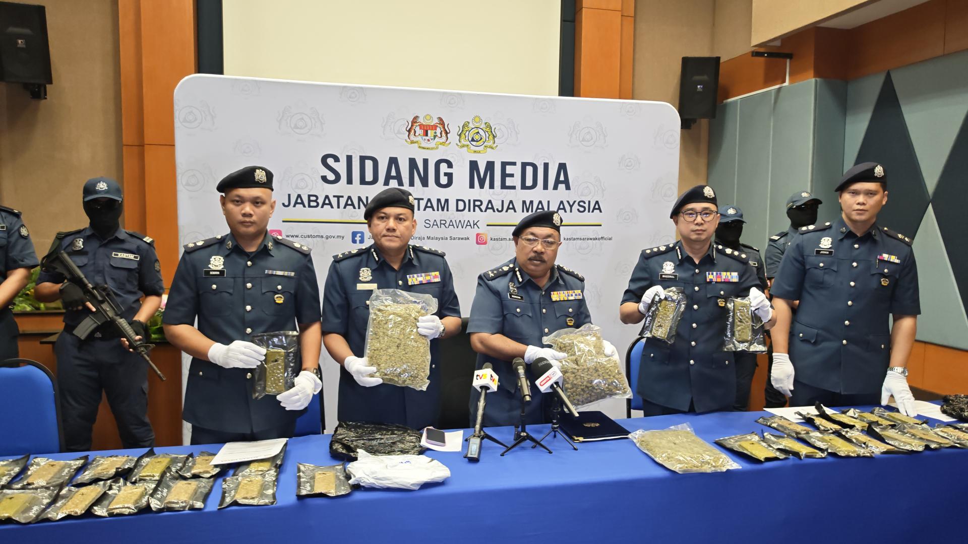 砂拉越关税局总监拿督哈芝诺里占（左3）向媒体展示价值较高的大麻花。