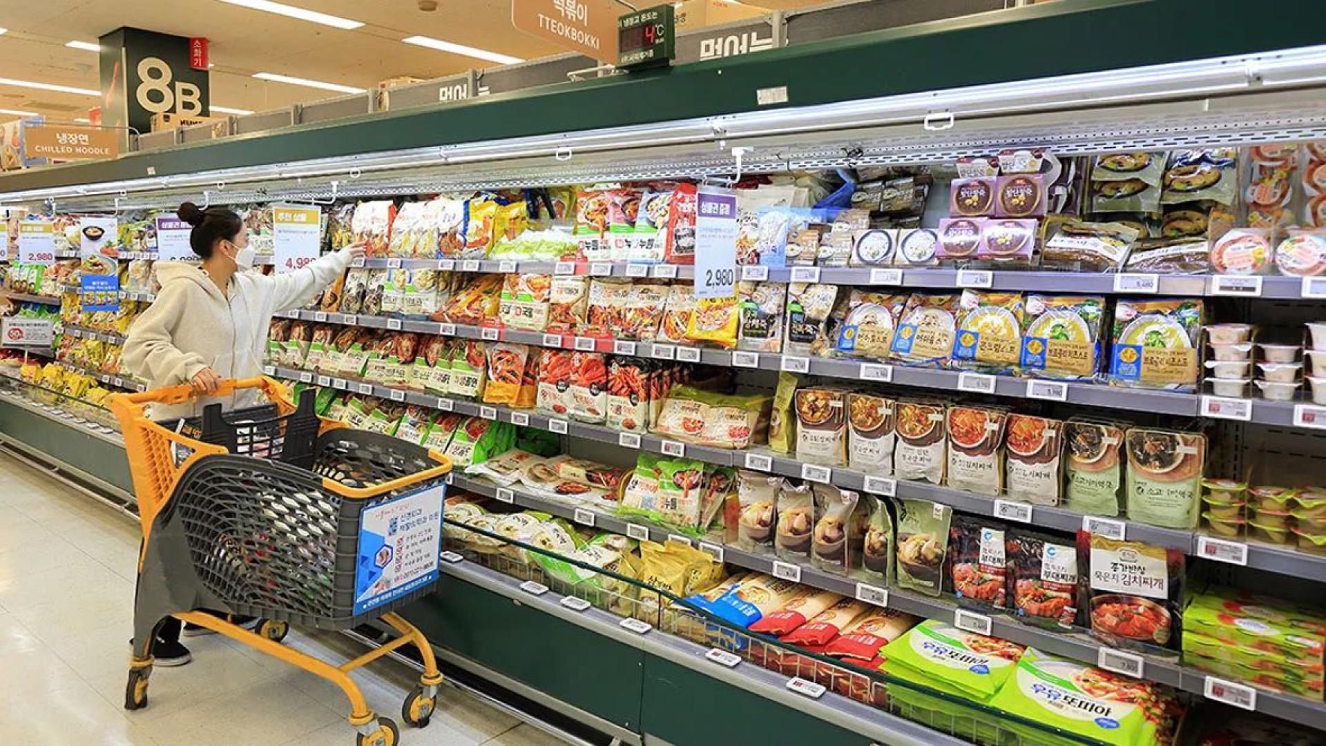 在韩国一名女顾客正在超级市场选购食品。