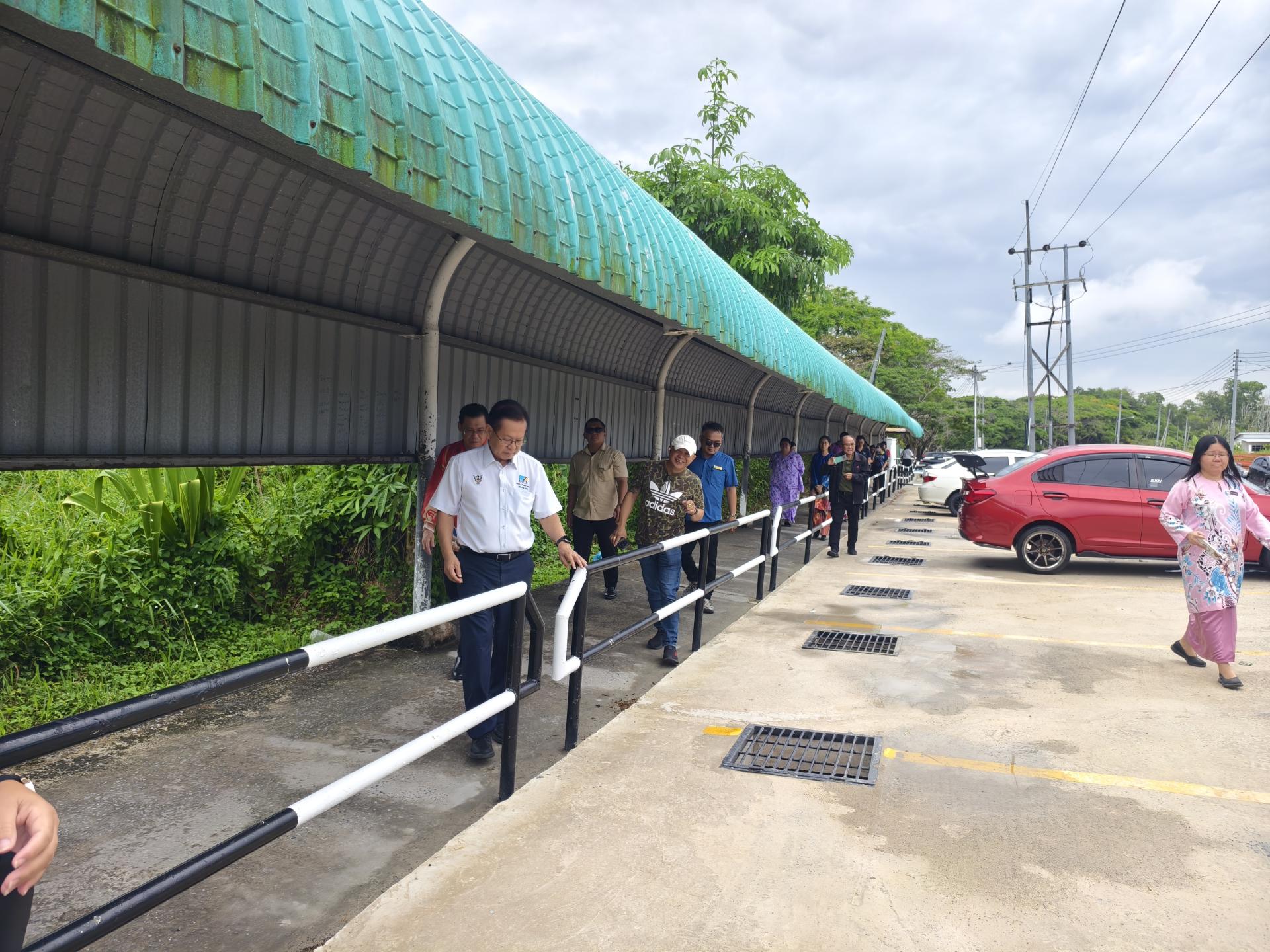 李景胜巡视杜当中华公学校前已完成的沟渠覆盖及停车场工程。