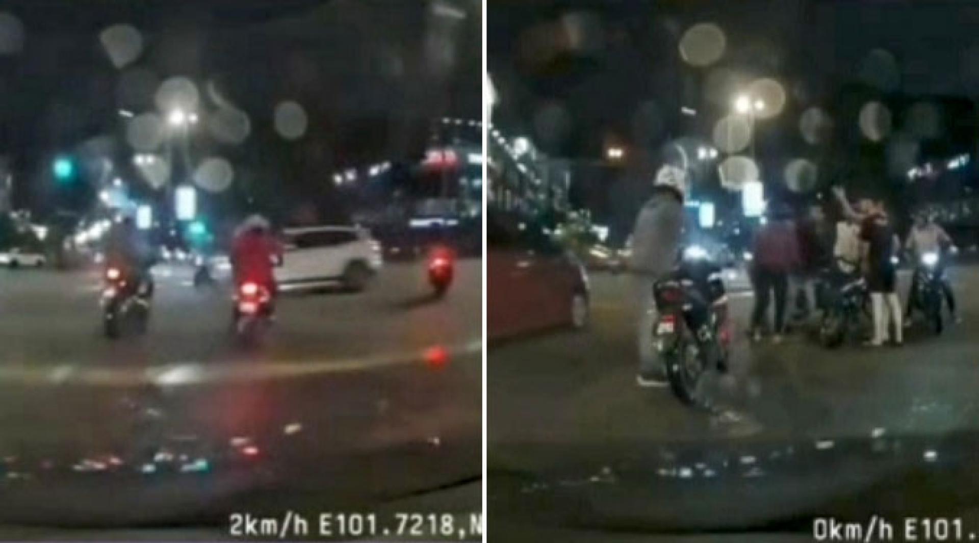 摩托车待红绿灯转为绿灯后向前行驶，不料一辆车子从另一车道行驶。（视频截图）