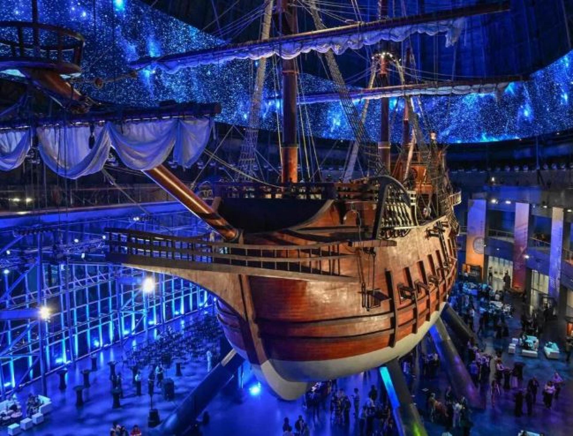 在全景灯光与星空投影映照下，参观者于4月23日在马尼拉“大帆船博物馆”内，仰望按原比例复刻的17世纪西班牙大帆船“圣灵号”。