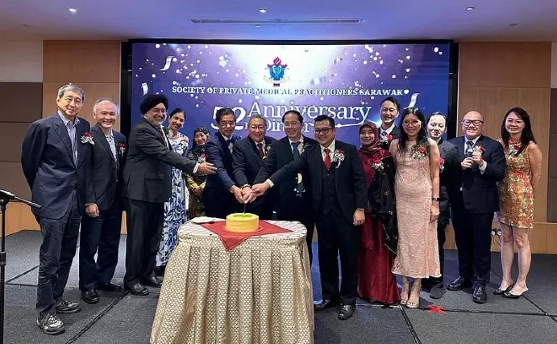 代表沈桂贤博士出席的黄鸿圣（左7）与嘉宾，于2026年7月11日在古晋某酒店举行的砂拉越私人执业医生协会52周年晚宴上合影。