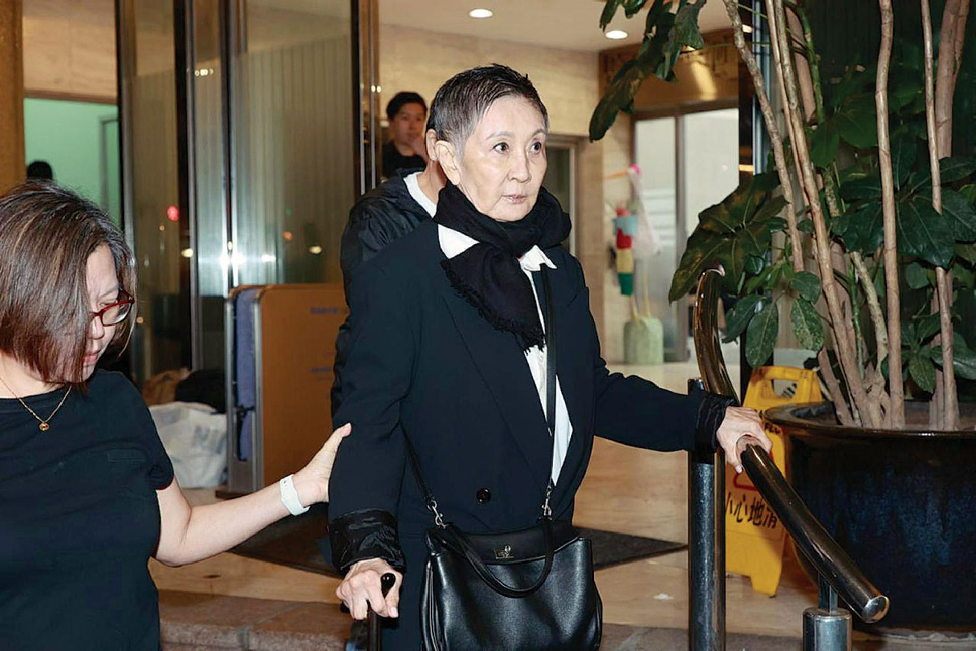 施南生手持拐杖送别亡友。