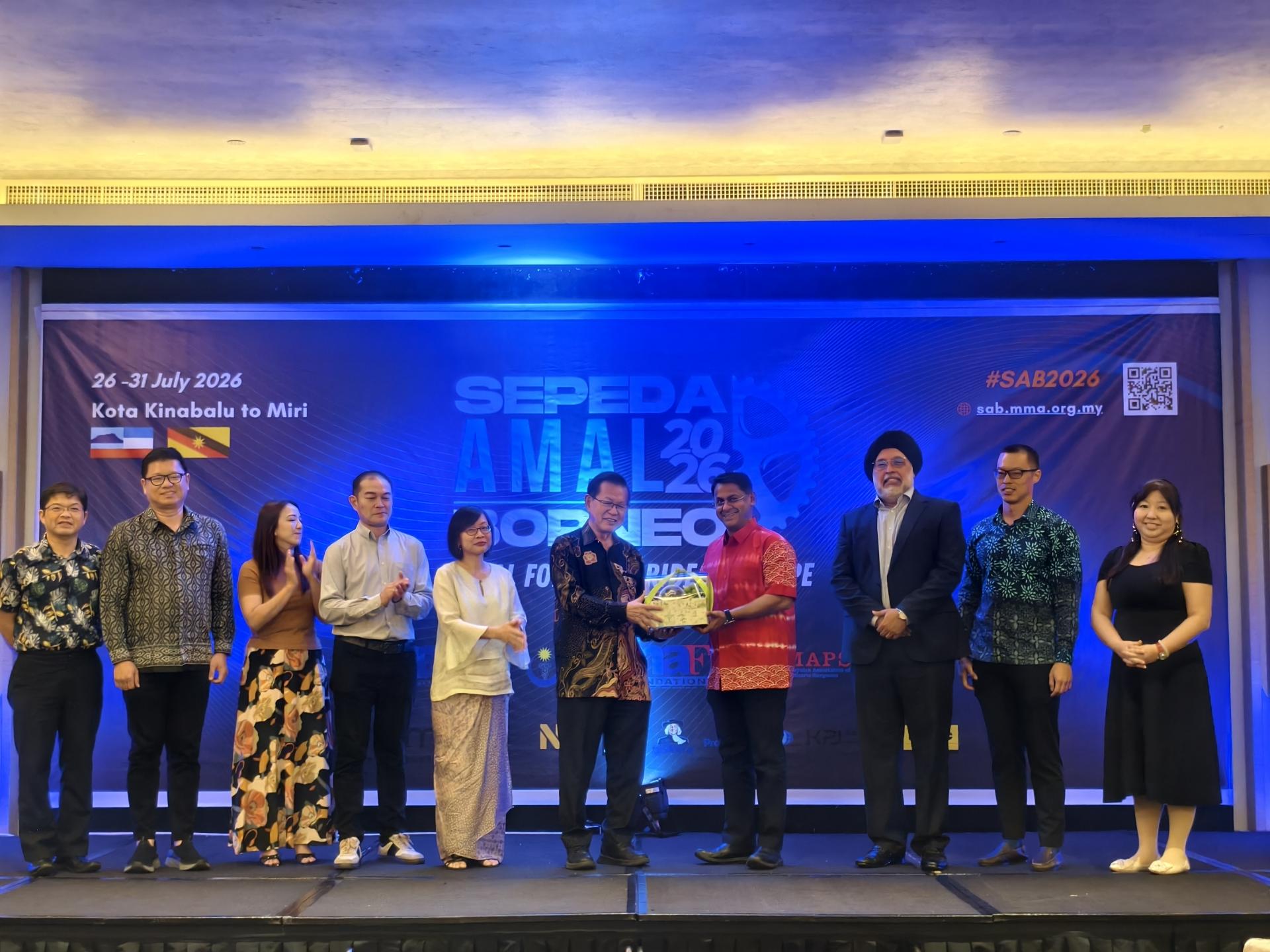大马医药协会主席拿督迪鲁纳巫卡拉苏（4）赠送水果篮给砂副总理拿督阿玛沈桂贤医生的代表砂拉越交通部长拿督斯里李景胜（左6）。右起为慈善筹款晚宴筹备会主席李惜汝医生、婆罗洲慈善骑行创办人兼主席郑信坚医生及大马医药协会前主席卡英德星医生；左起为美里医院院长黄修儒医生，美里市政局旅游发展工作小组主席兼市议员范宏祥，大马原发性免疫系统缺陷病家长协会主席林伟忠（左4）及大马儿科外科协会主席蓝汉燕博士教授（左5）。
