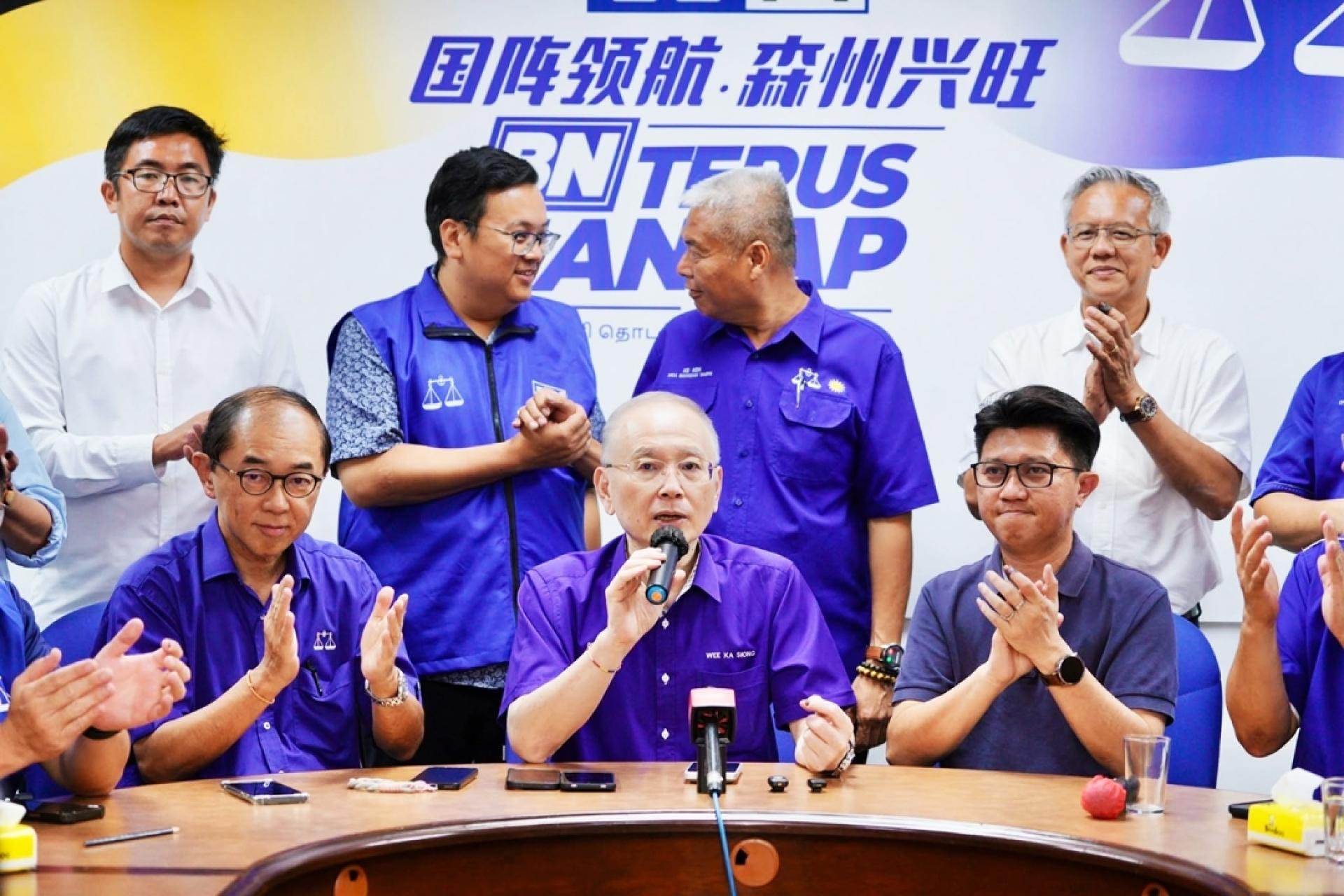 萧康骏（后排左2起）和许金水在马华领导层的新闻发布会上，互相勉励。